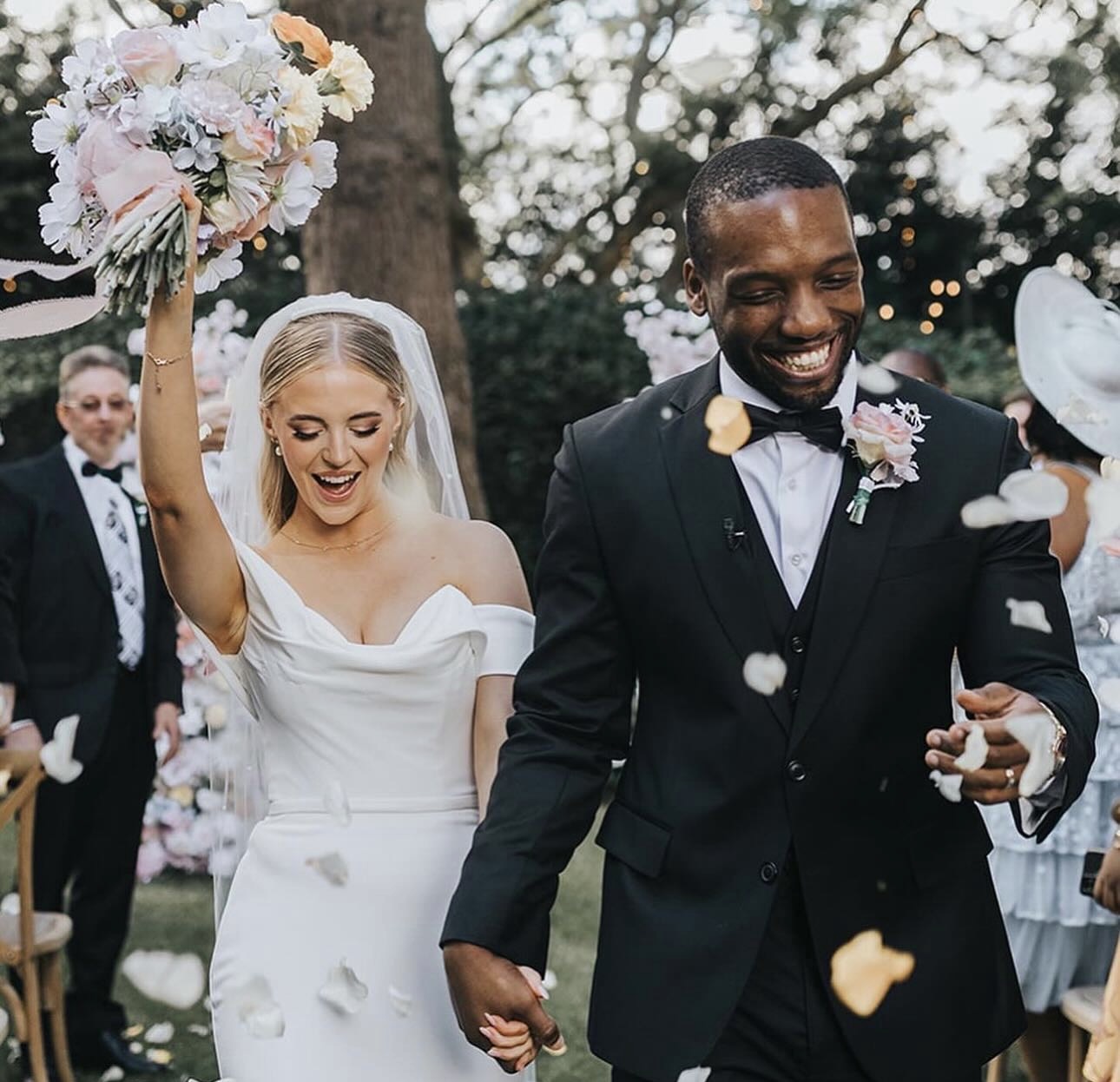 Bride and groom walking down the aisle with confetti