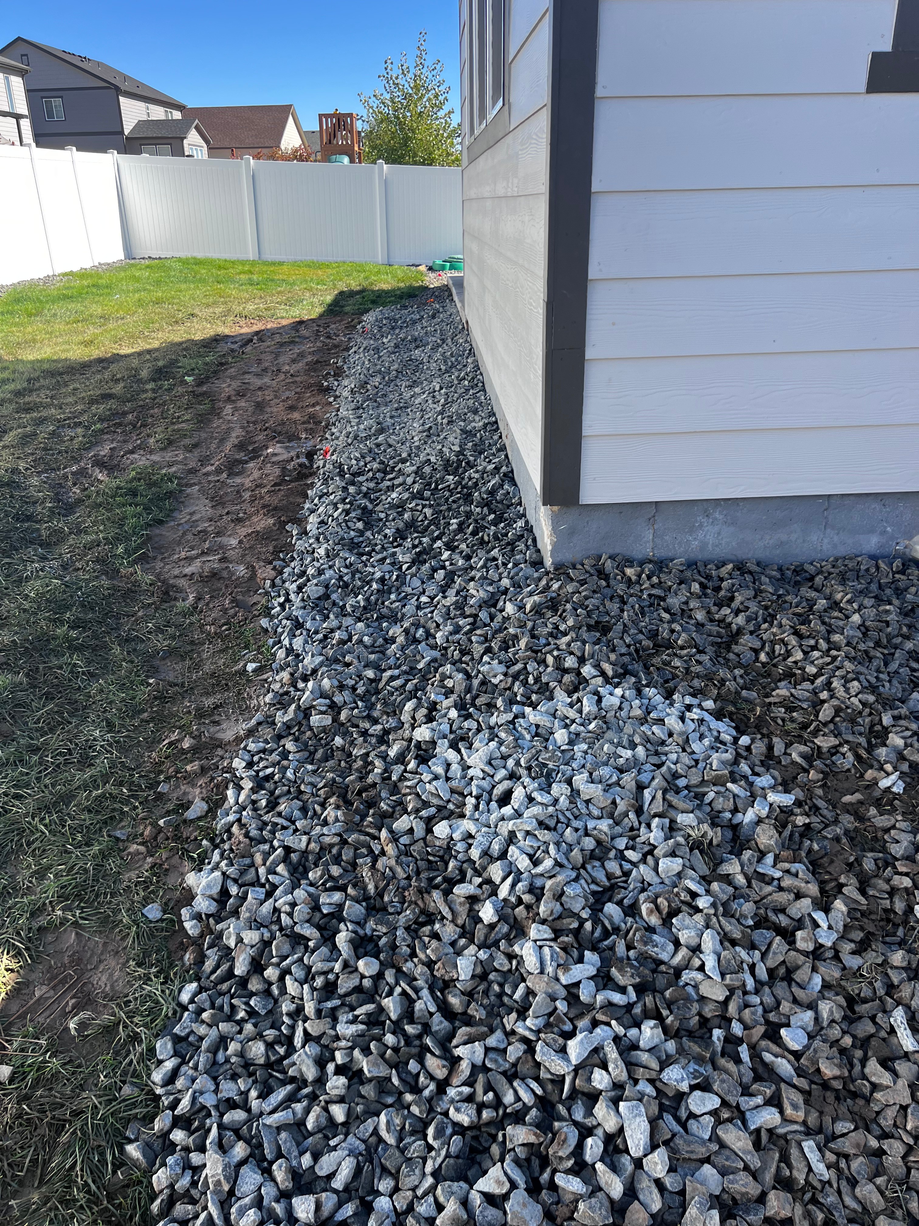 Gravel drainage along foundation of house