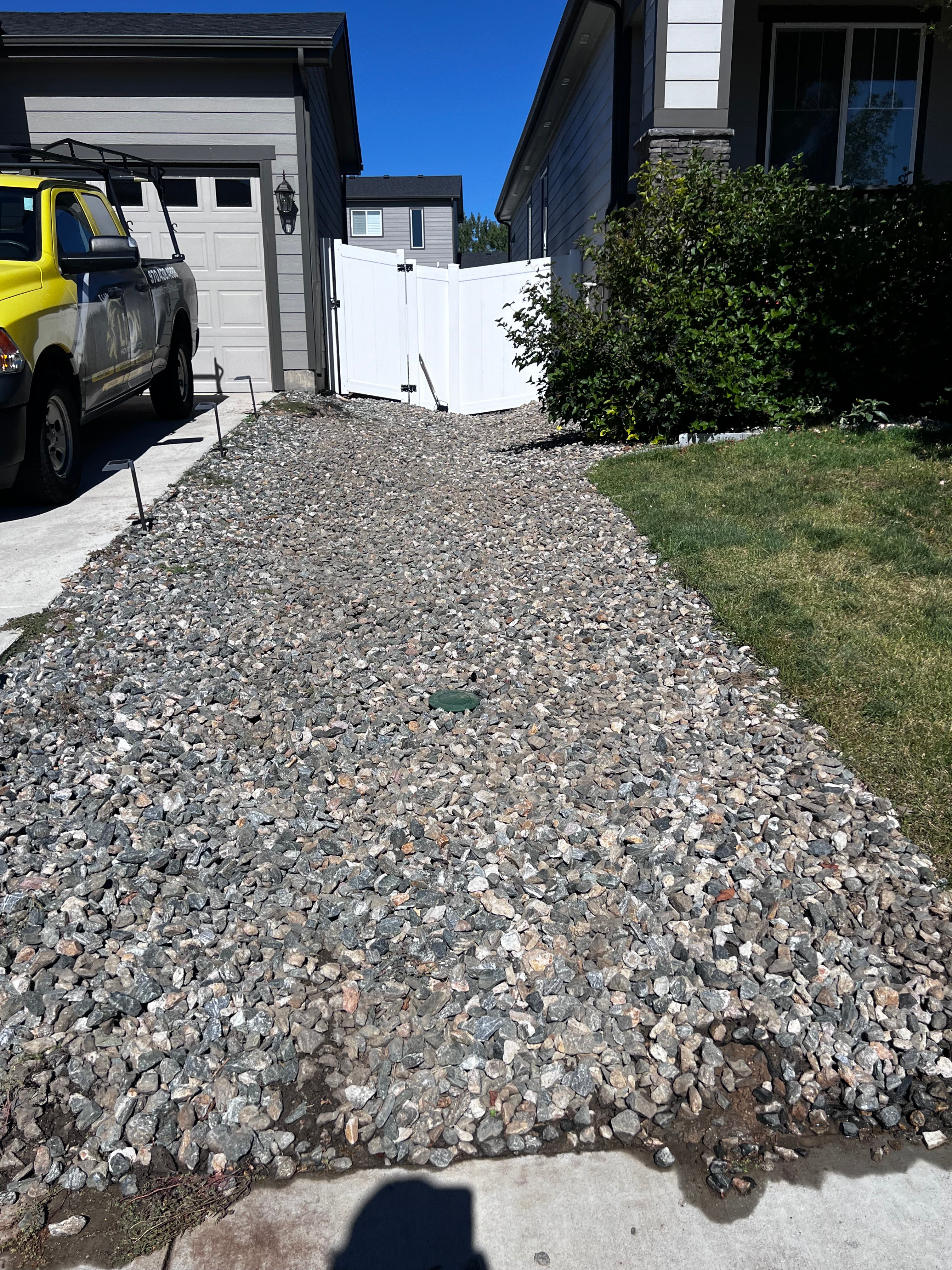 Completed gravel drainage area with septic lid next to house