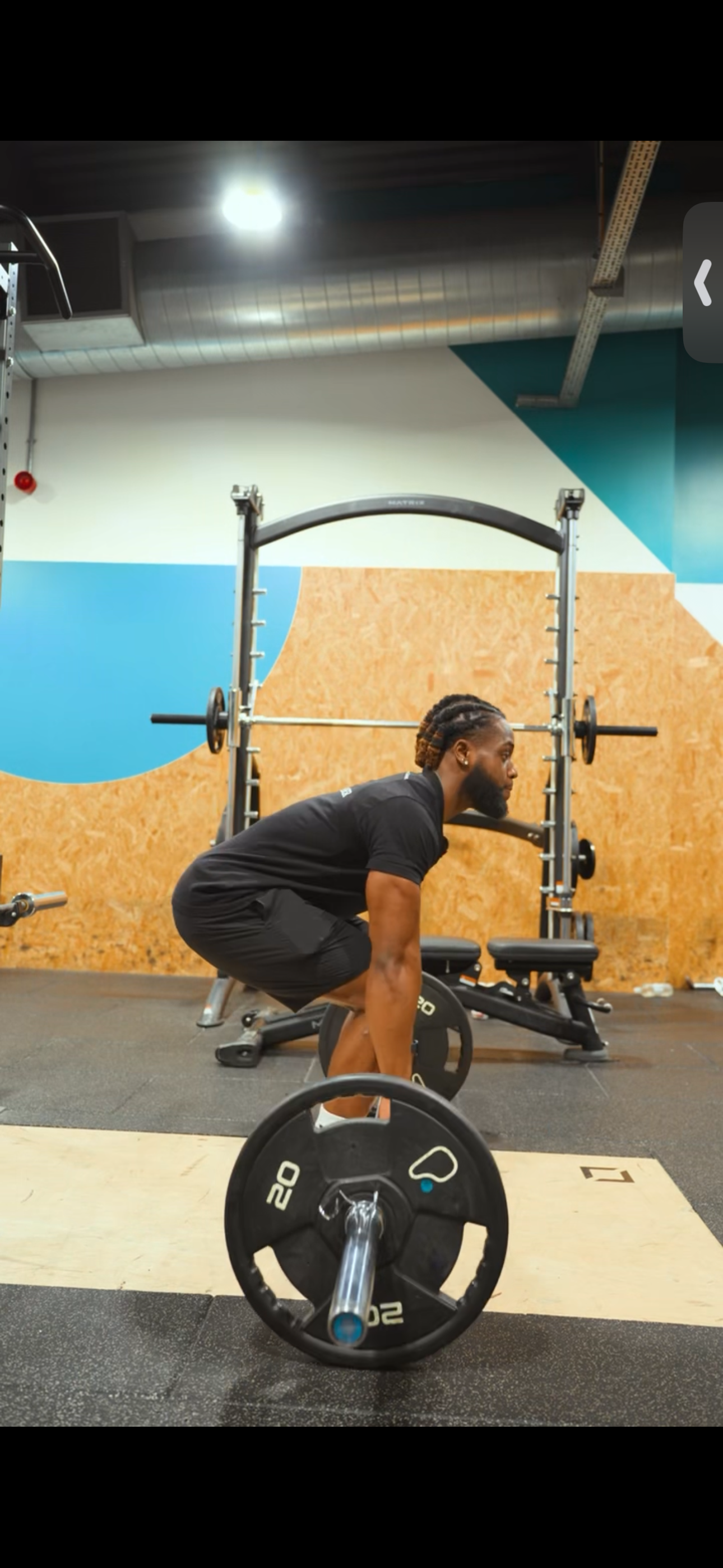 Fadel performing a deadlift at the gym