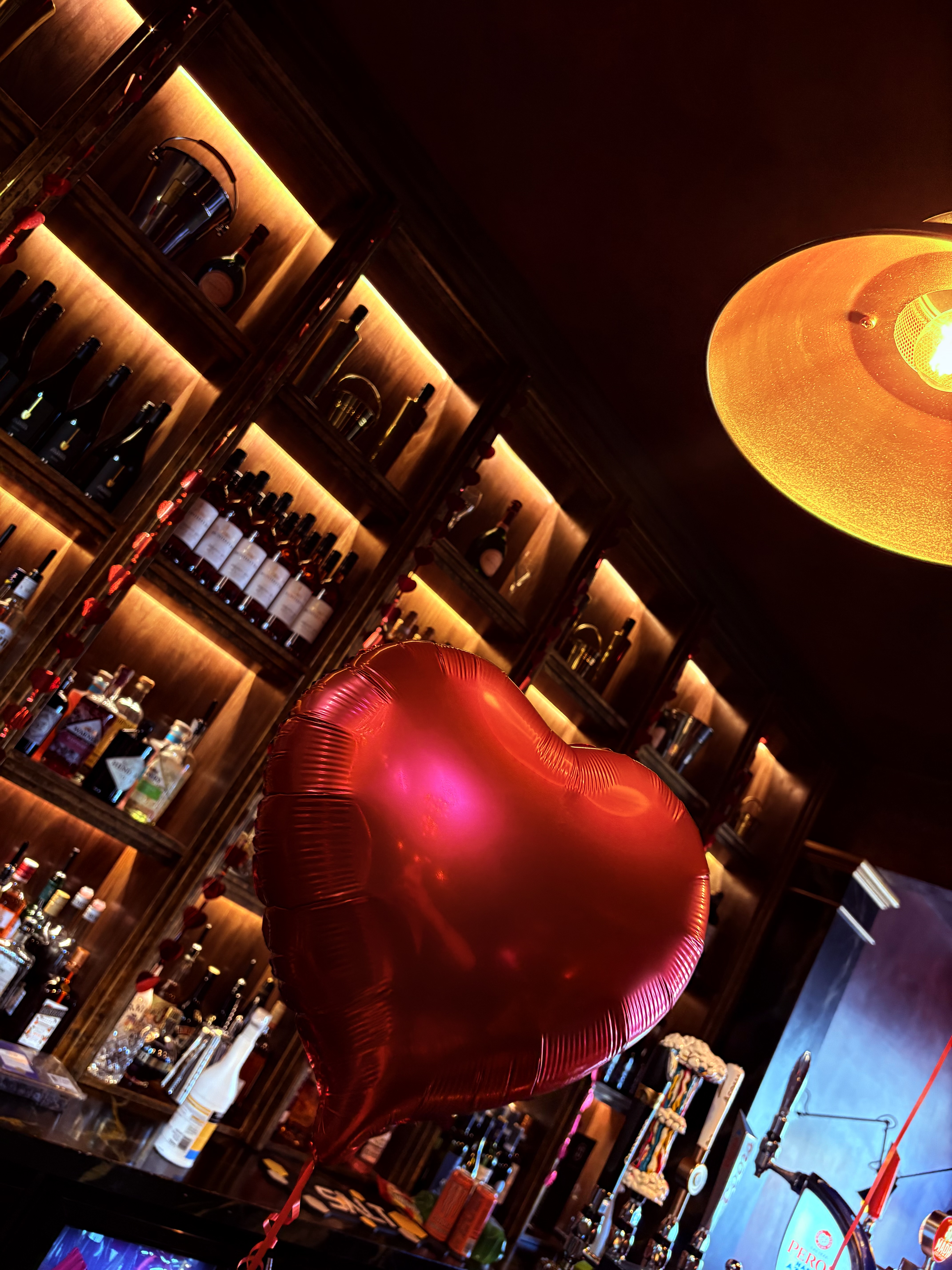 Heart balloon decoration at the bar with backlit shelves