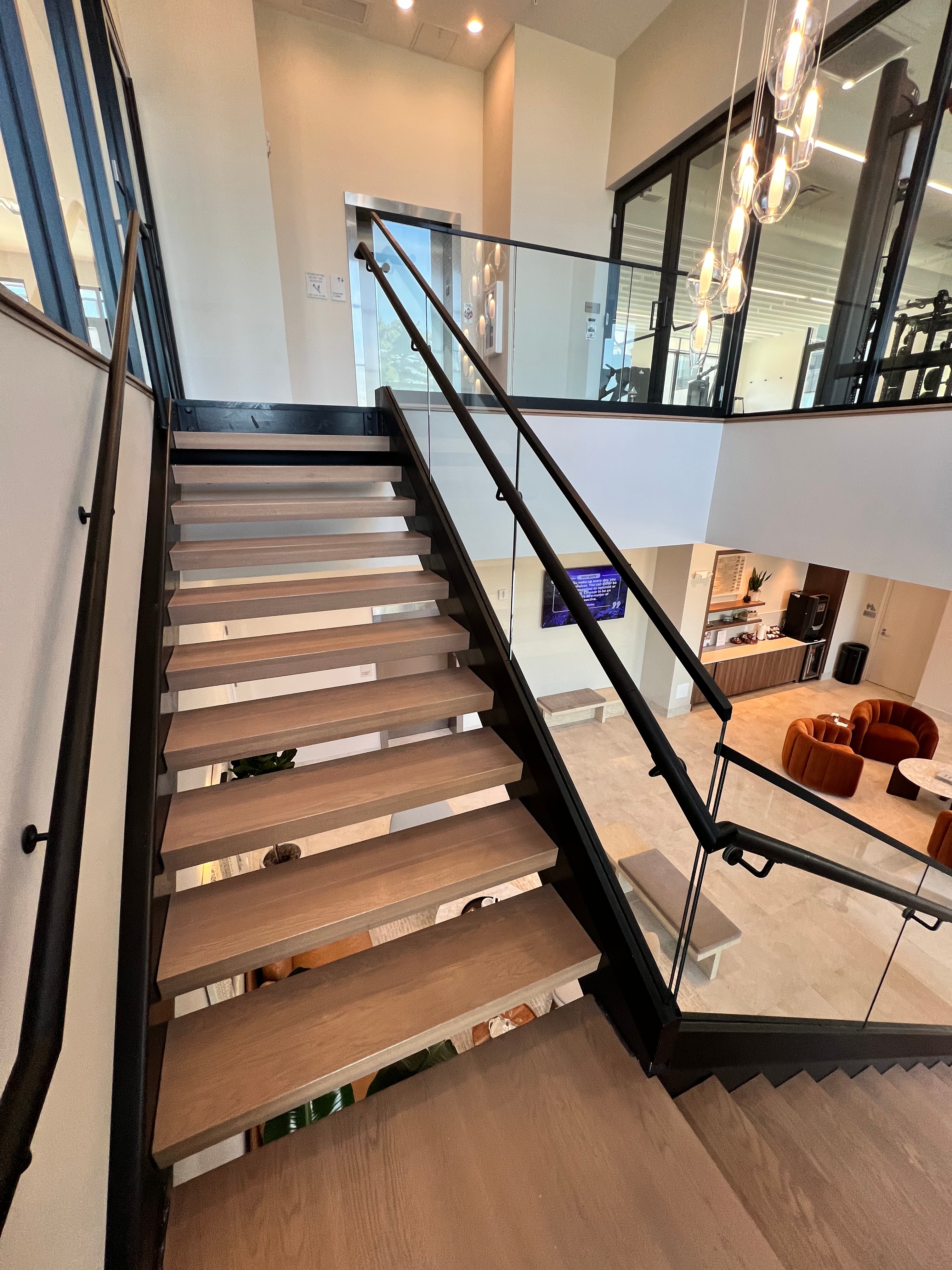Modern Open-Riser Stair — Structural Glass with Black Steel Stringer