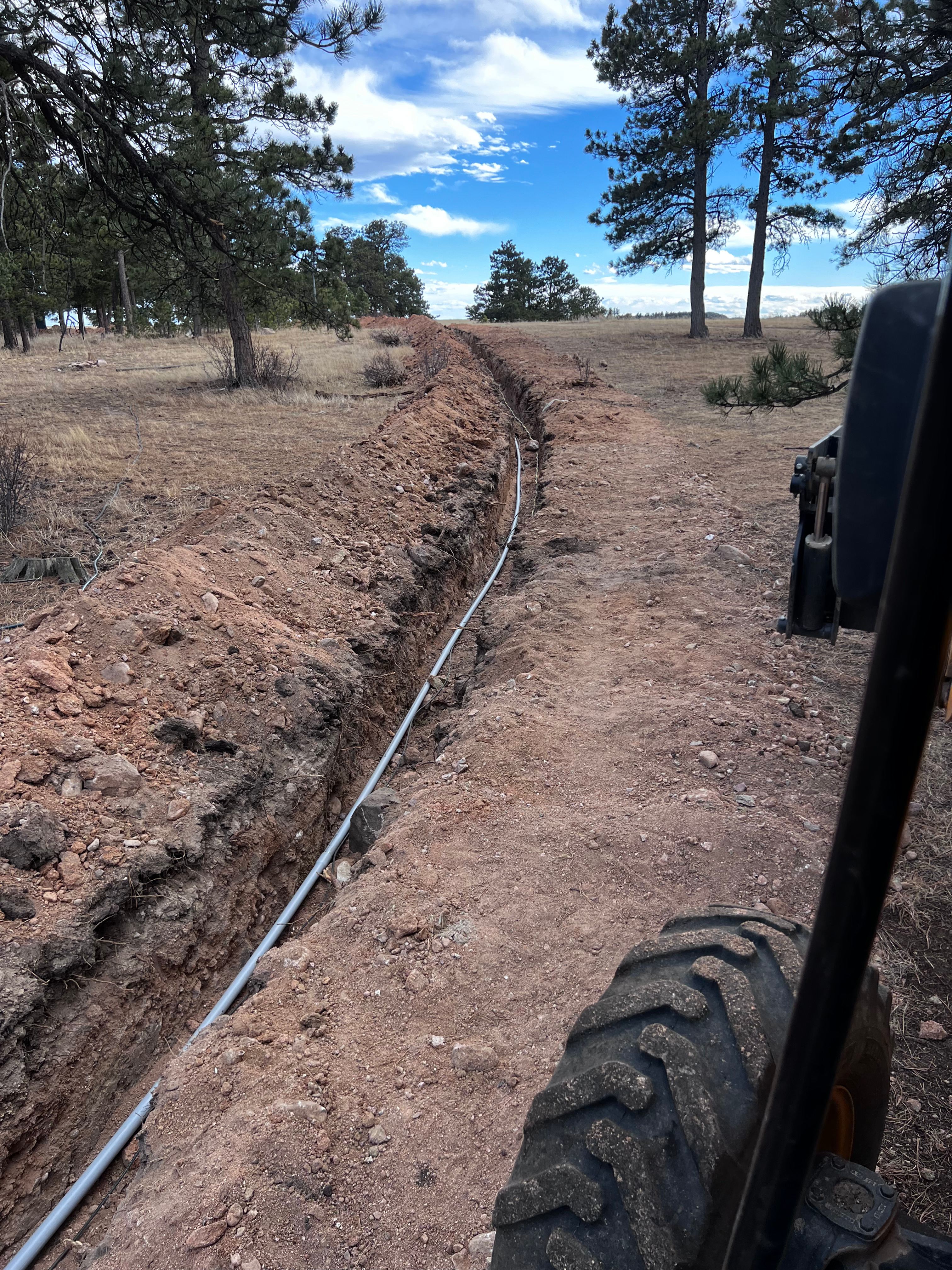 Utility trench with pipe in rural Colorado mountain setting