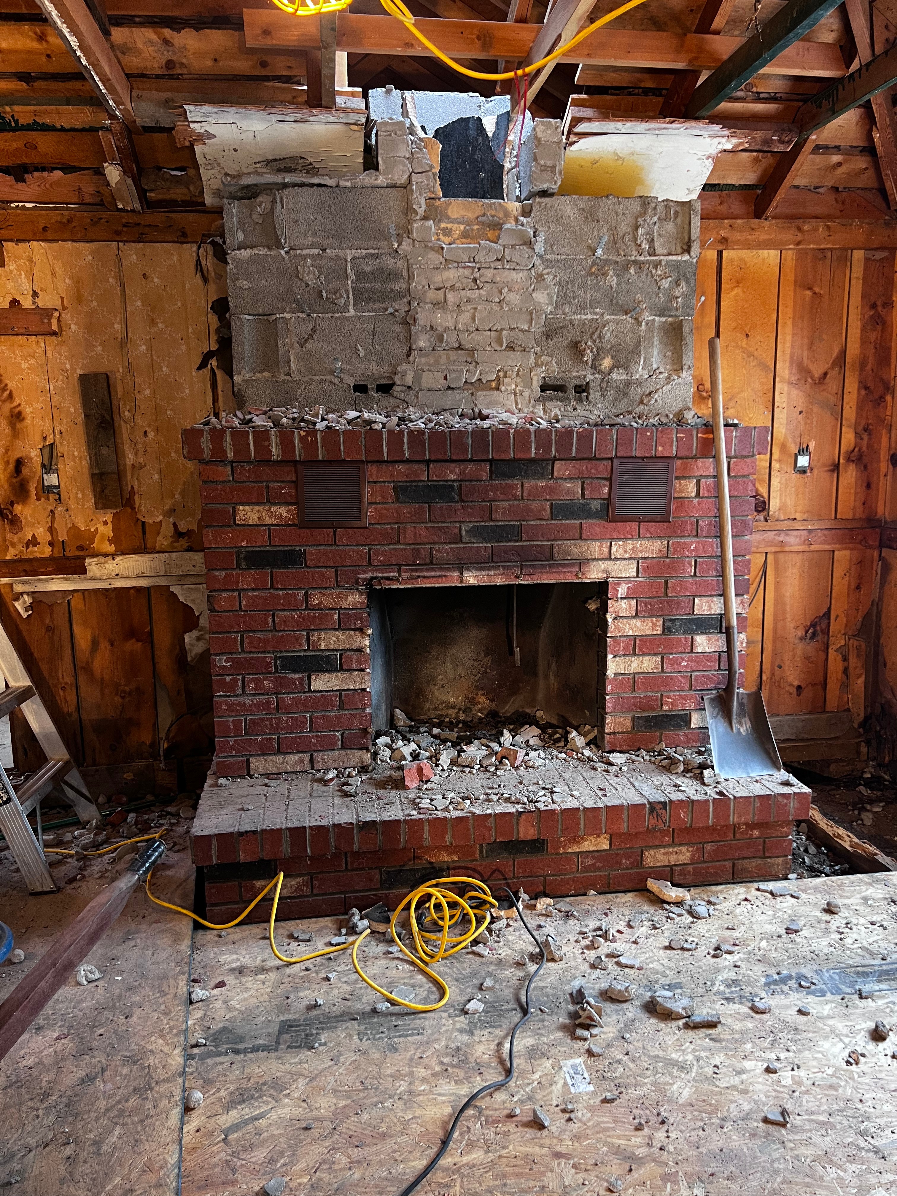 Brick fireplace and chimney demolition in progress