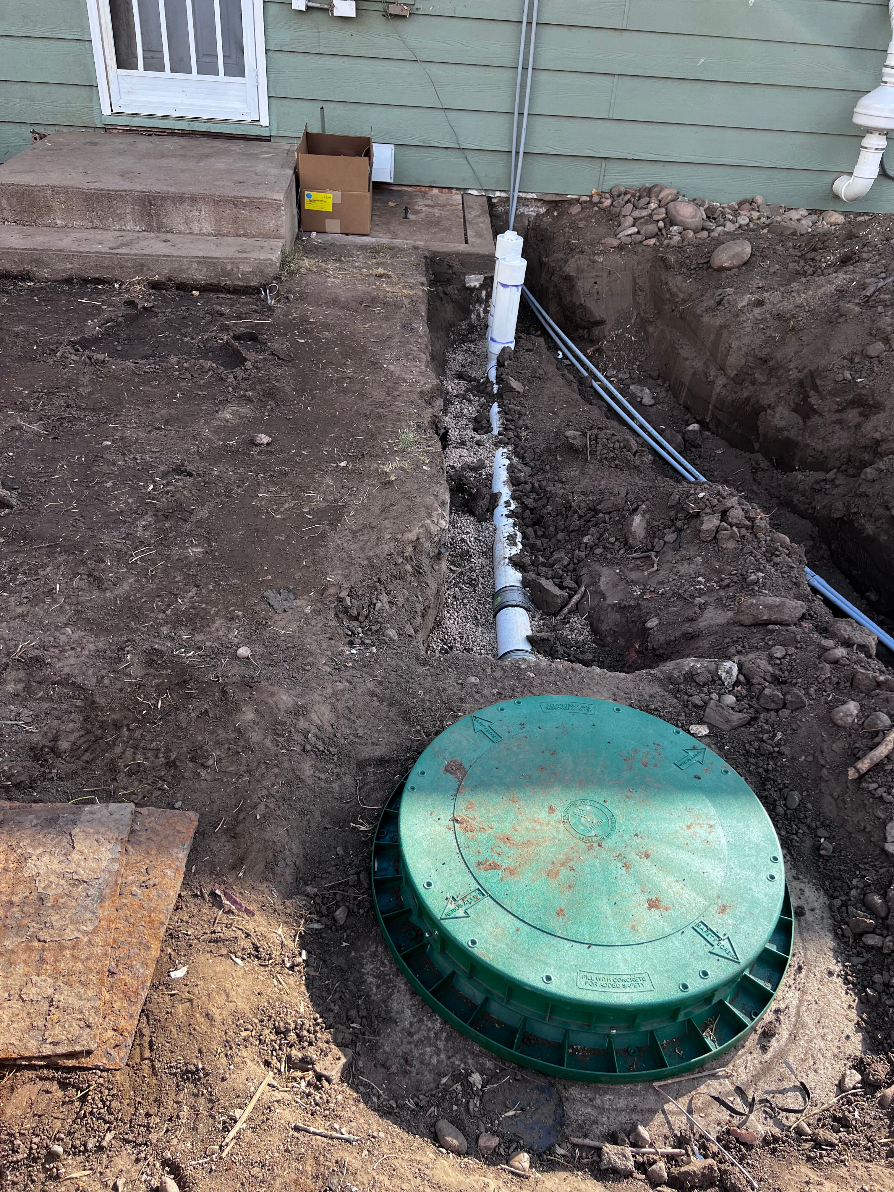 Green septic tank access lid with new PVC inlet piping