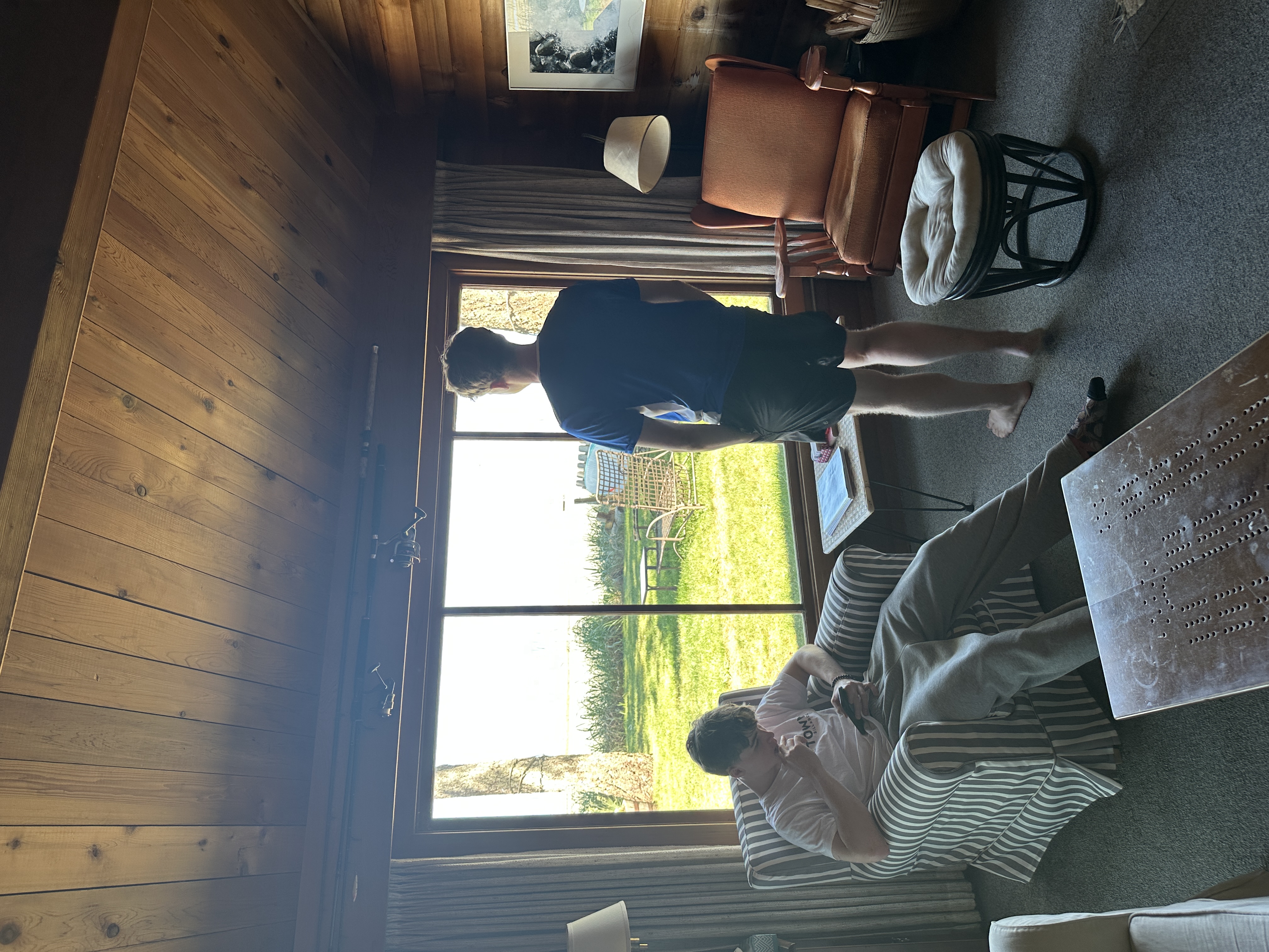 Chris cleaning the inside of a large living room window to a streak-free finish
