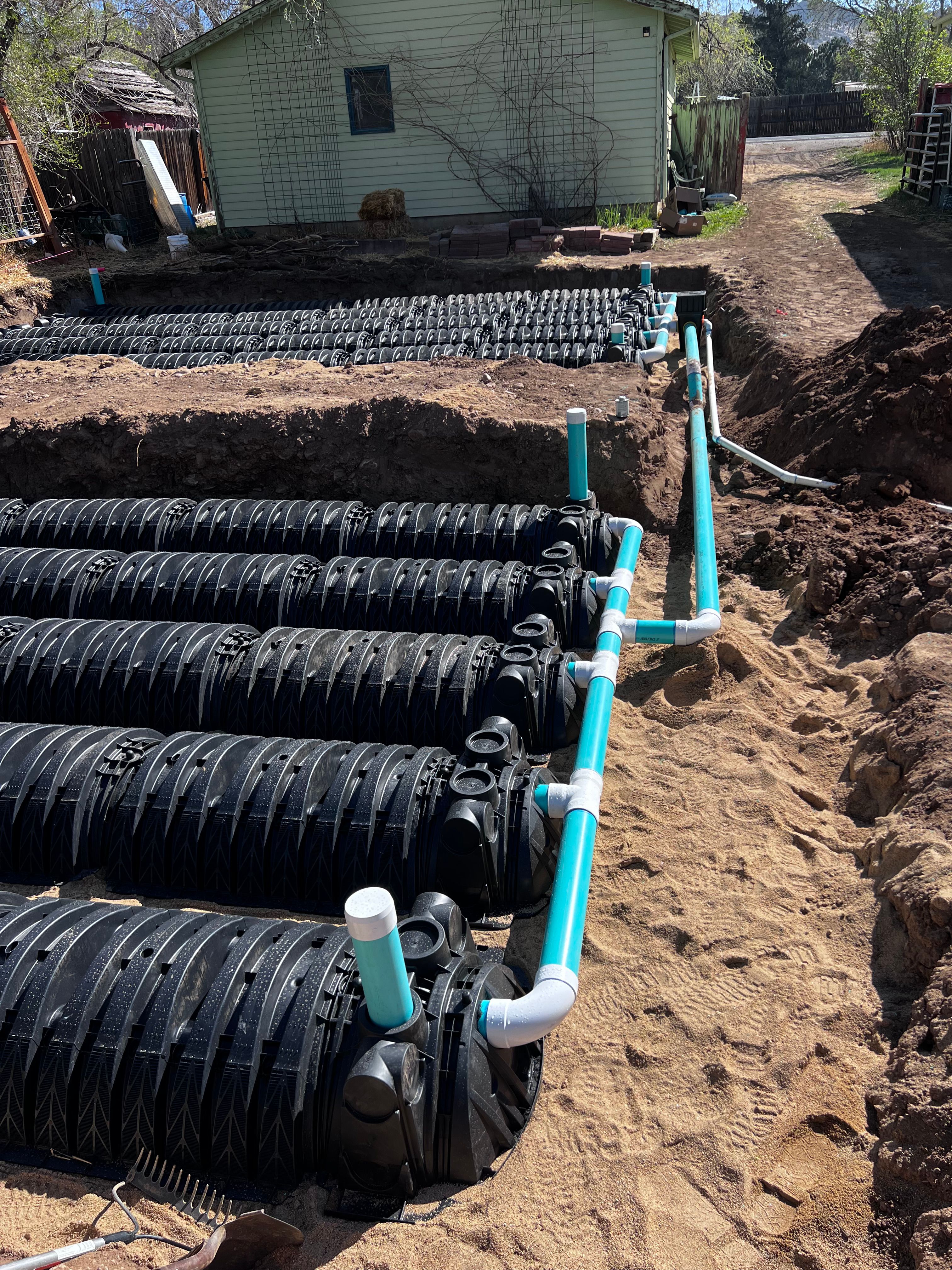 Septic leach field chambers with turquoise PVC distribution lines
