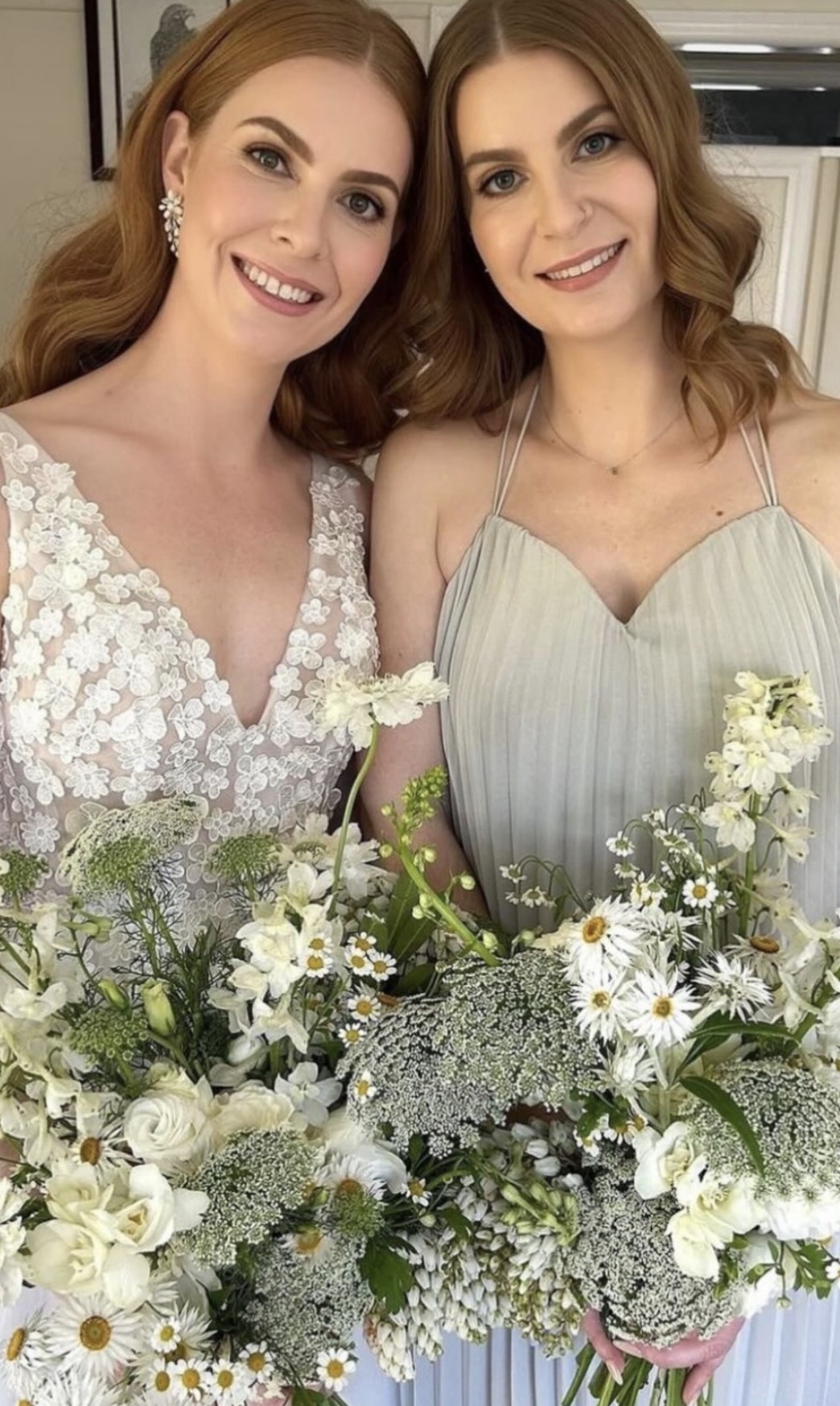 Bride and bridesmaid with natural radiant makeup holding wildflower bouquets