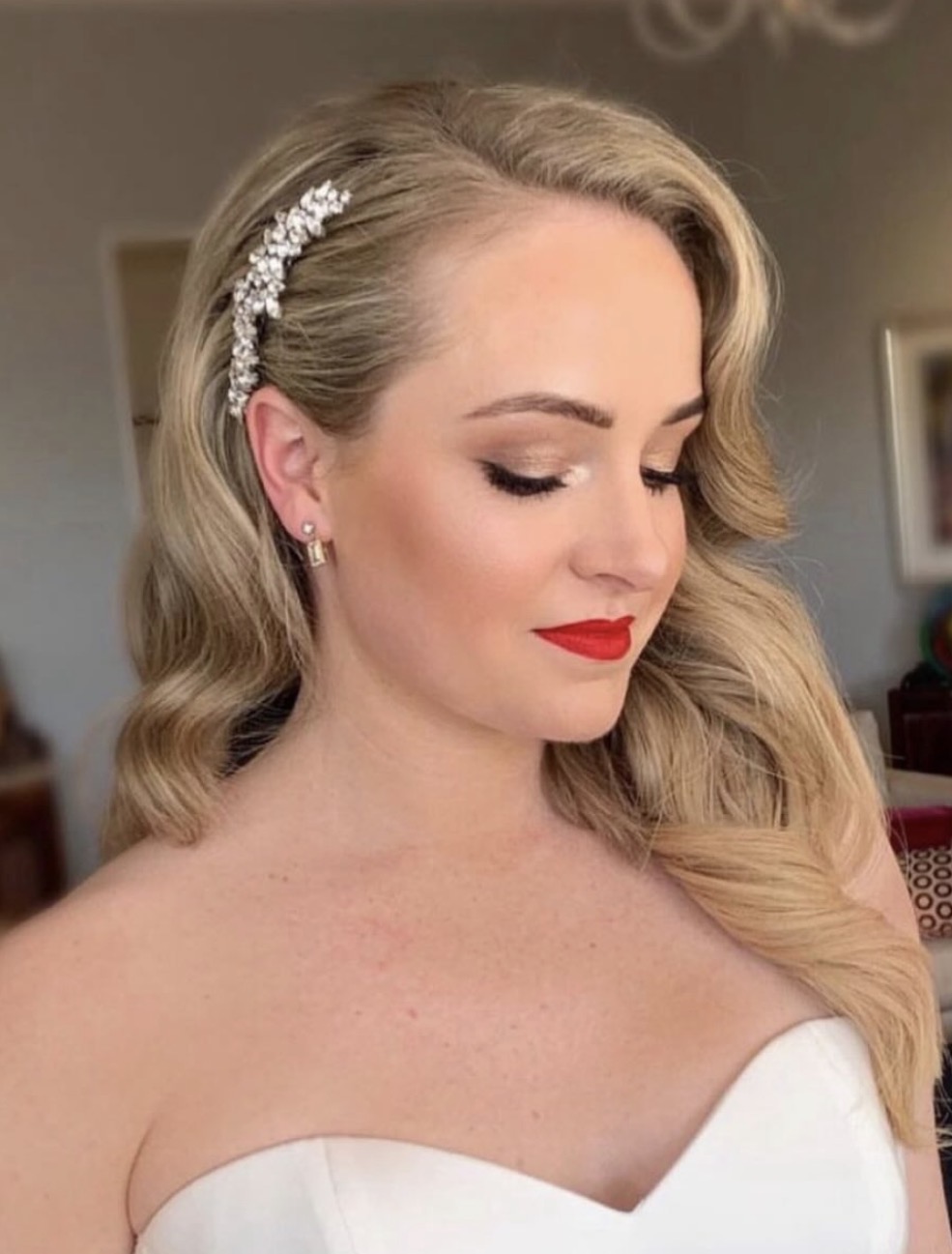 Bride with classic red lip, soft waves and a crystal hair comb