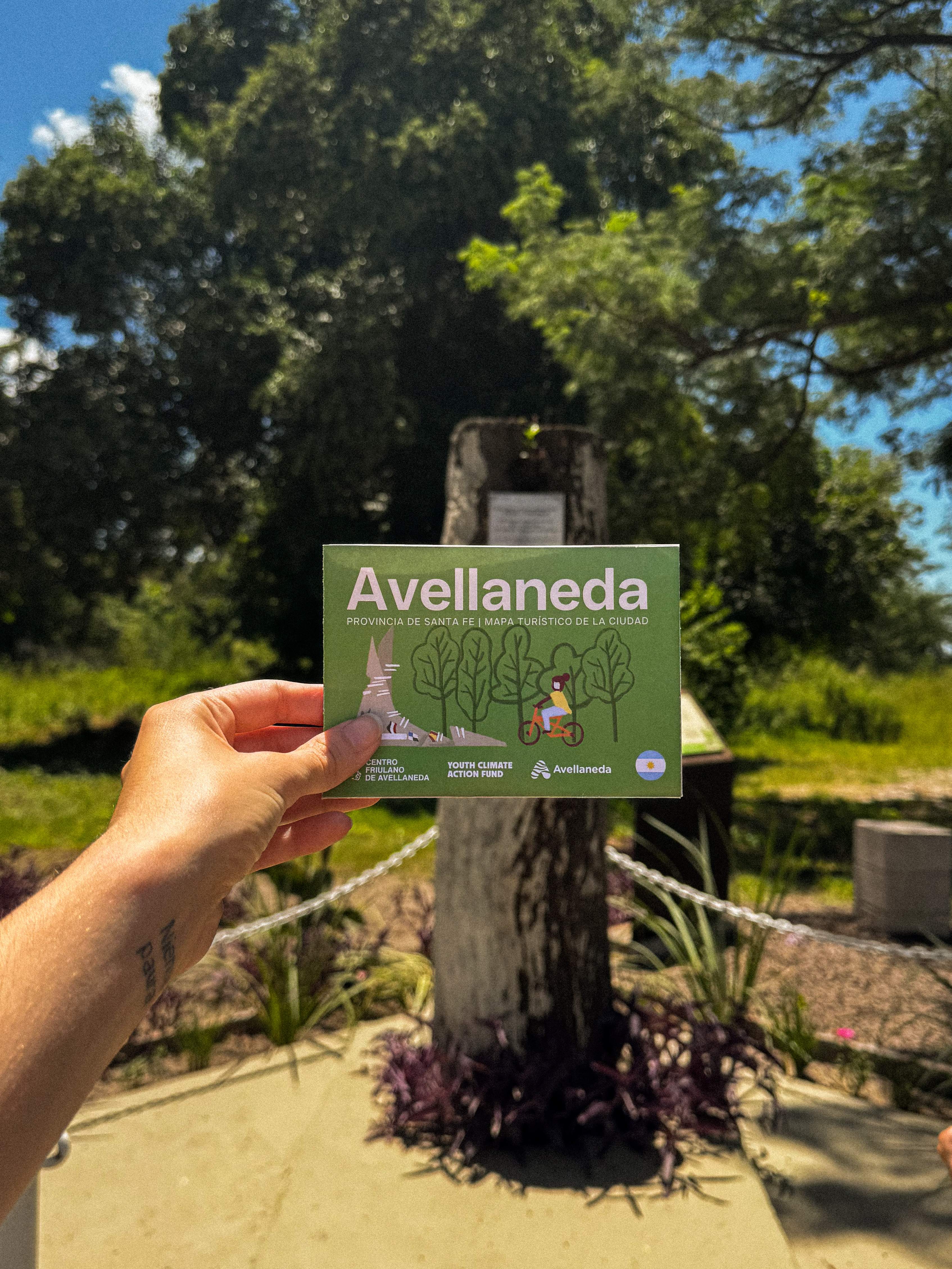 Mapa turístico Avellaneda - Folleto frente al monumento con árboles