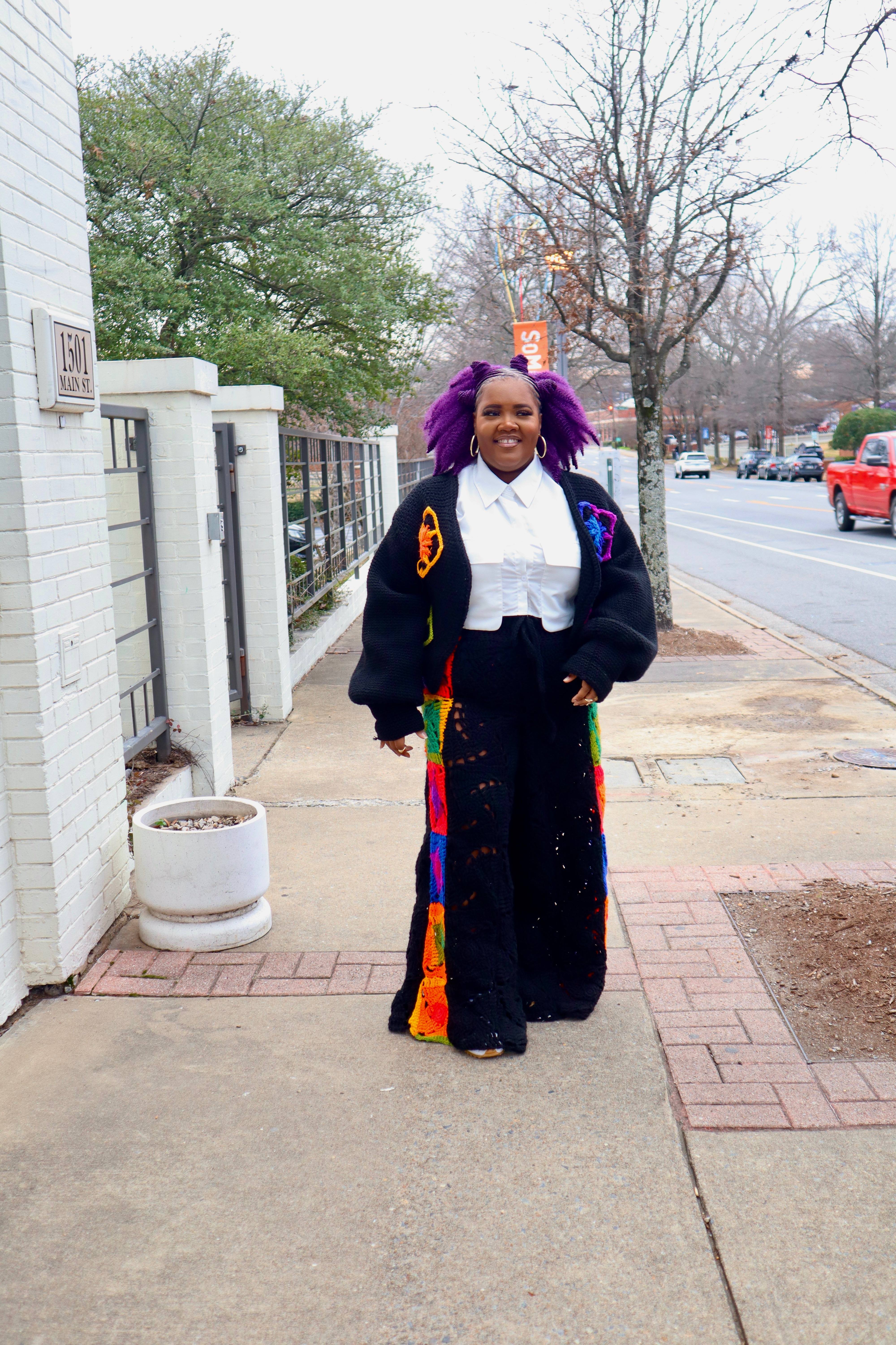 Ms. Callie with her signature purple hair and colorful crocheted cardigan on Main Street in Little Rock
