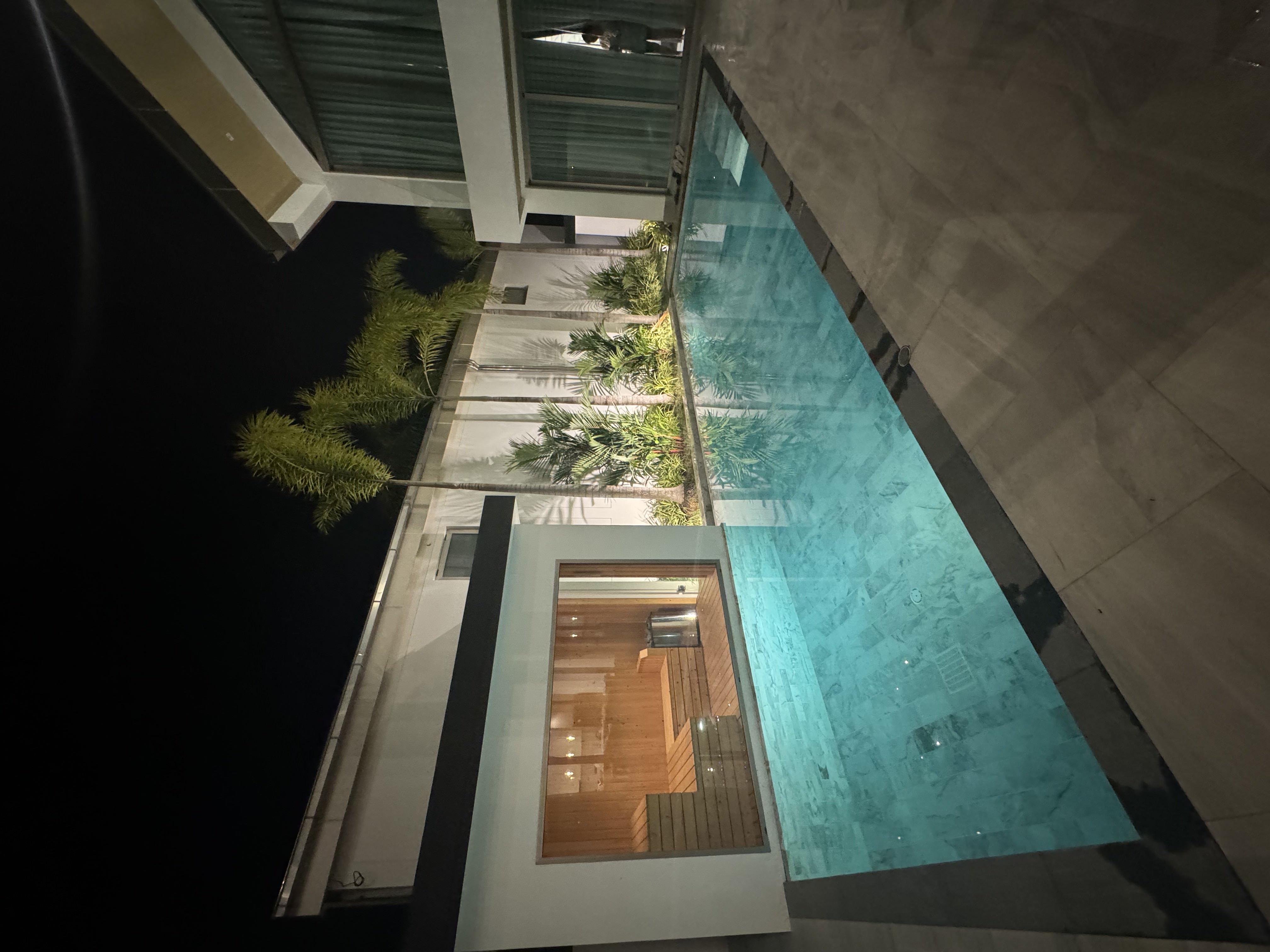 Luxury Grand View Residence villa with illuminated pool and sauna at night