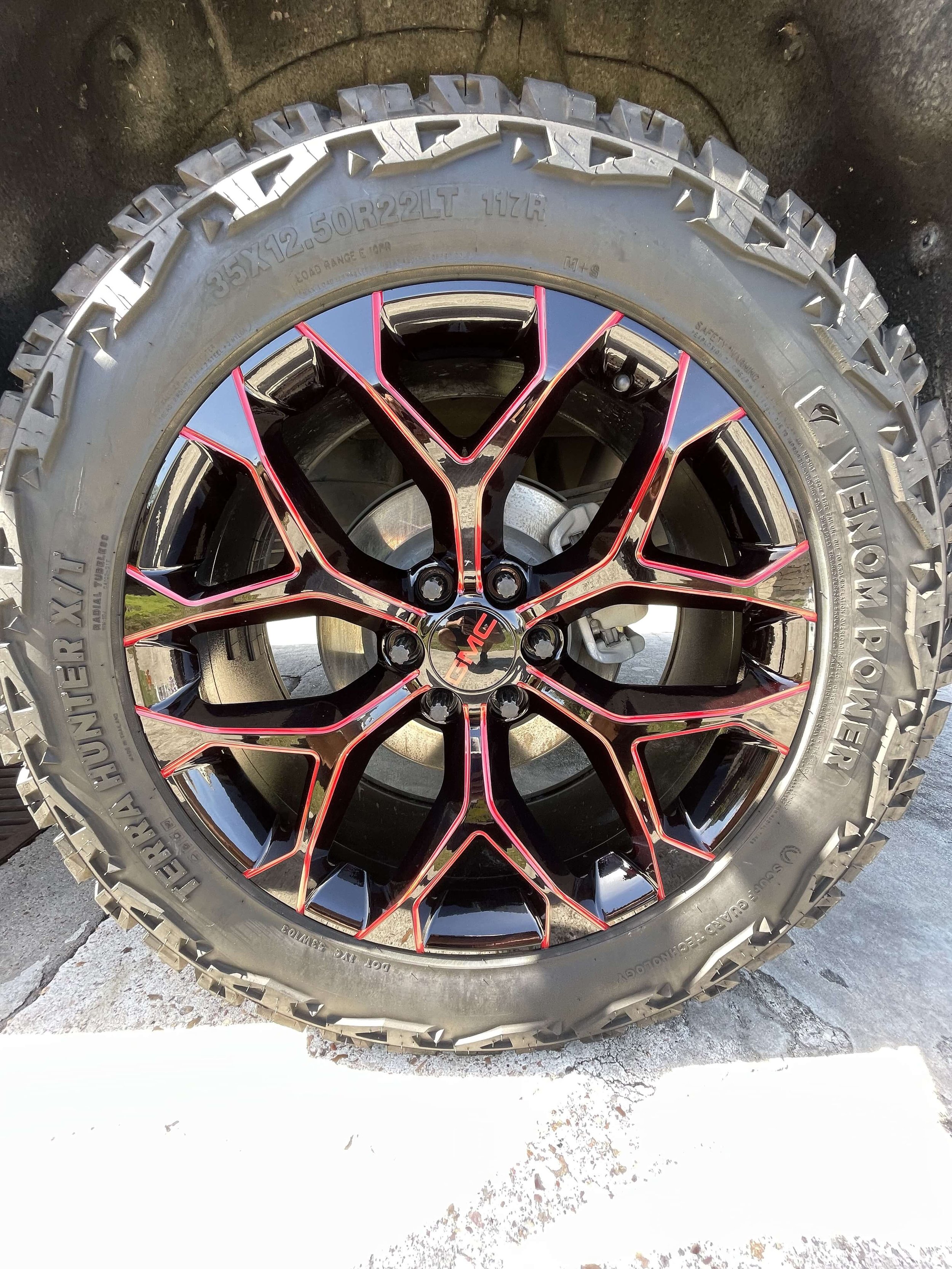 GMC wheel with red-milled gloss black rim, deep-cleaned tire and barrel