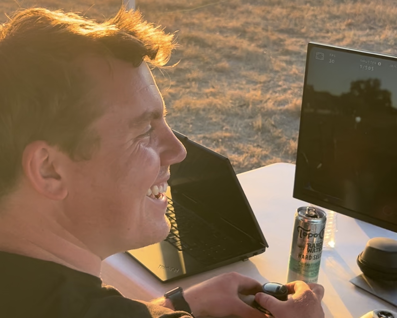 Attendee working on laptop during golden hour
