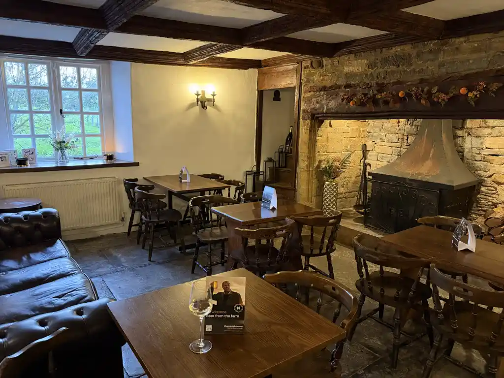 Dining room with stone fireplace and oak beams