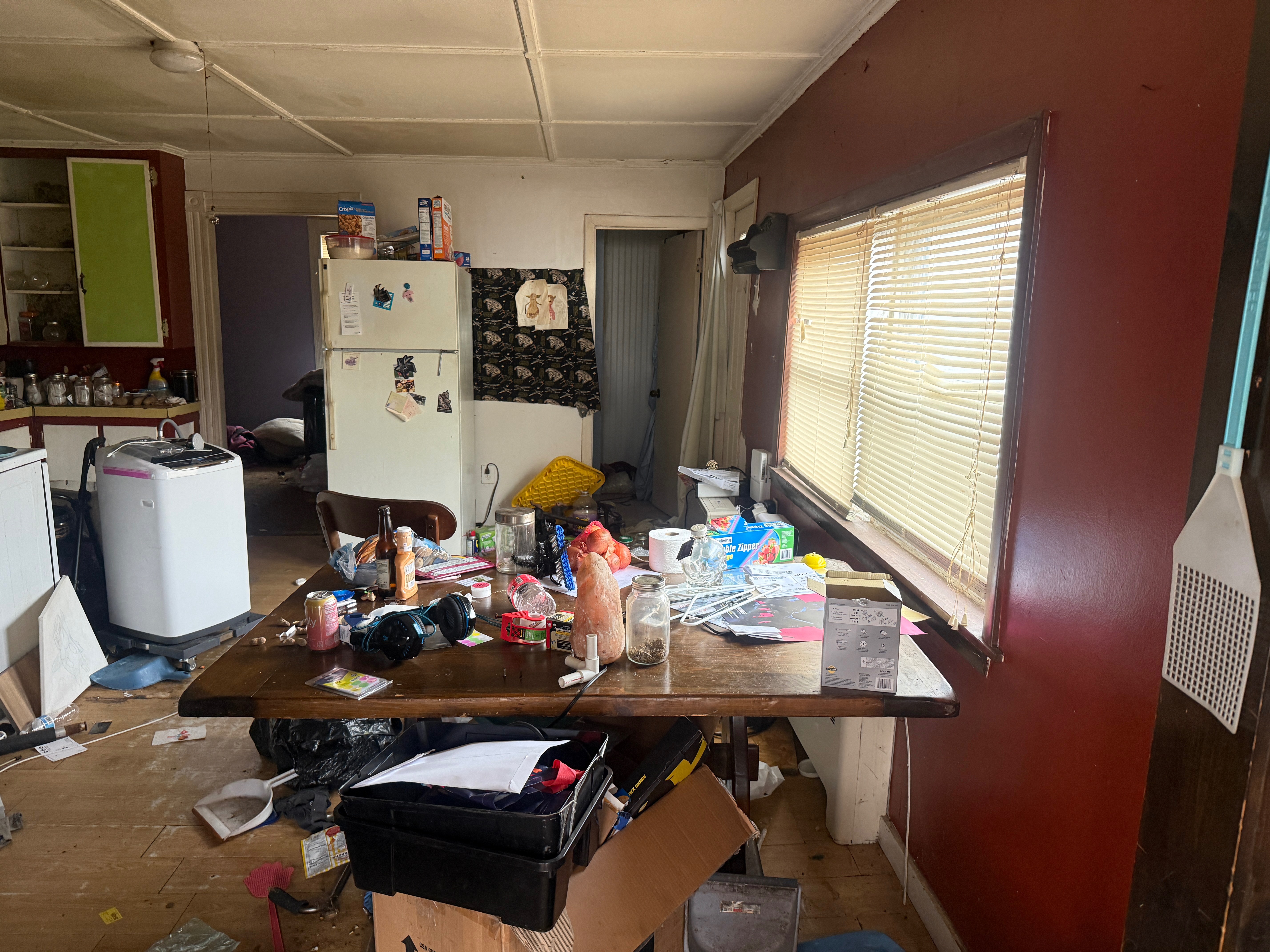 Property cleanout before - cluttered living space