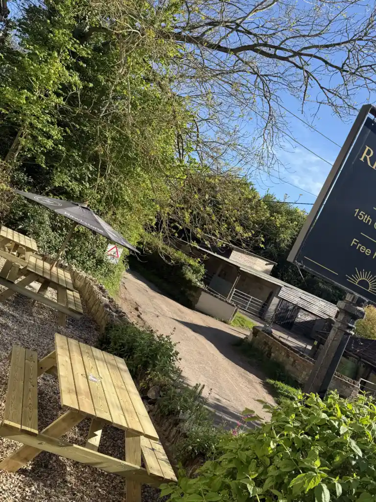 Beer garden with picnic benches and pub sign