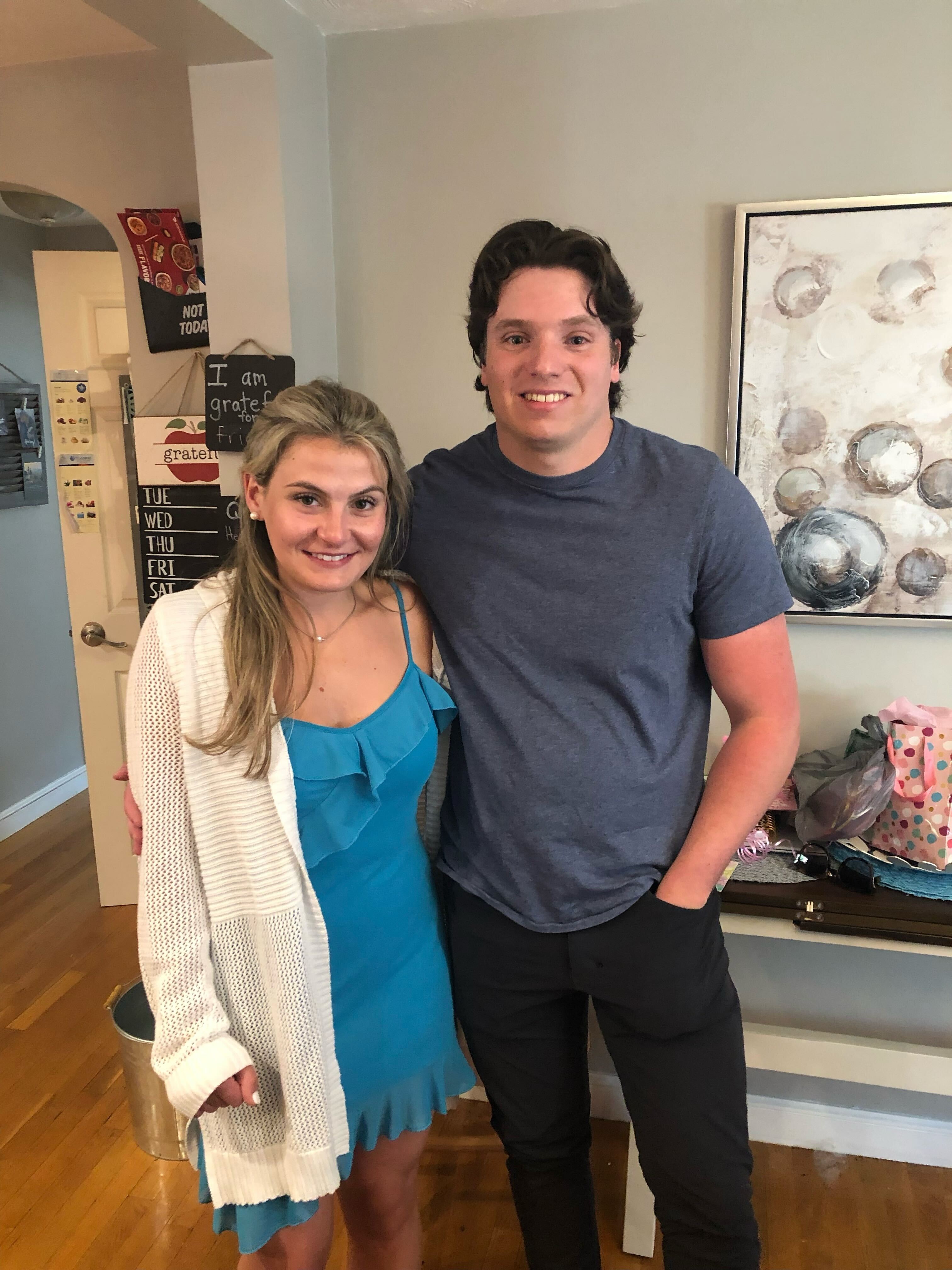 Ben and Brooke at home, Brooke in a blue dress and white cardigan, Ben in a grey t-shirt