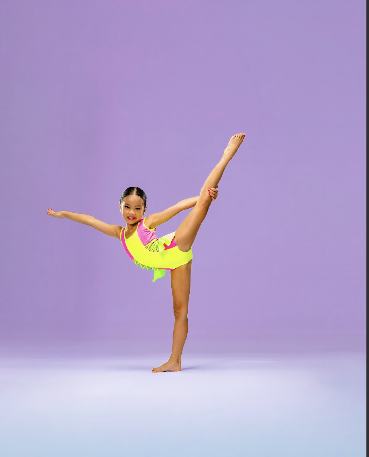 Young dancer Pichara Luong performing a standing split