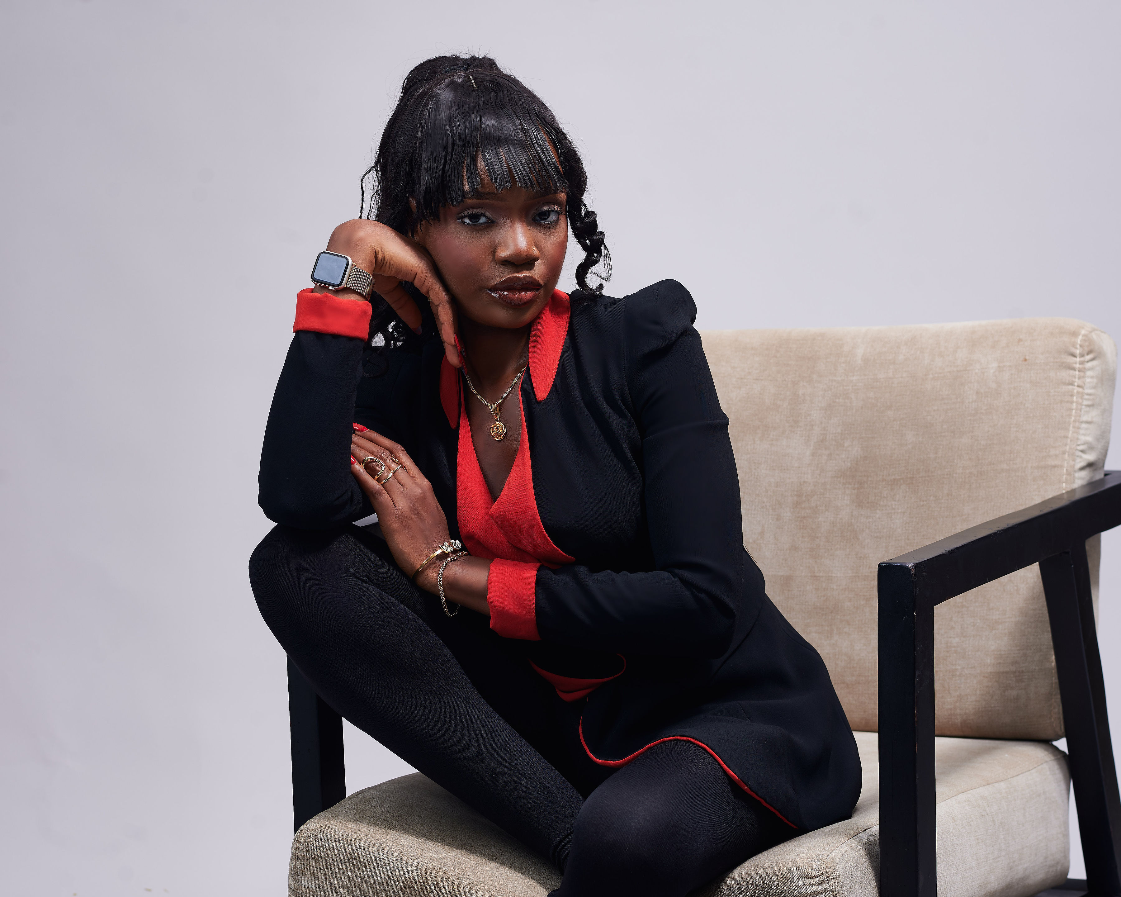 Suliat in a black and red suit