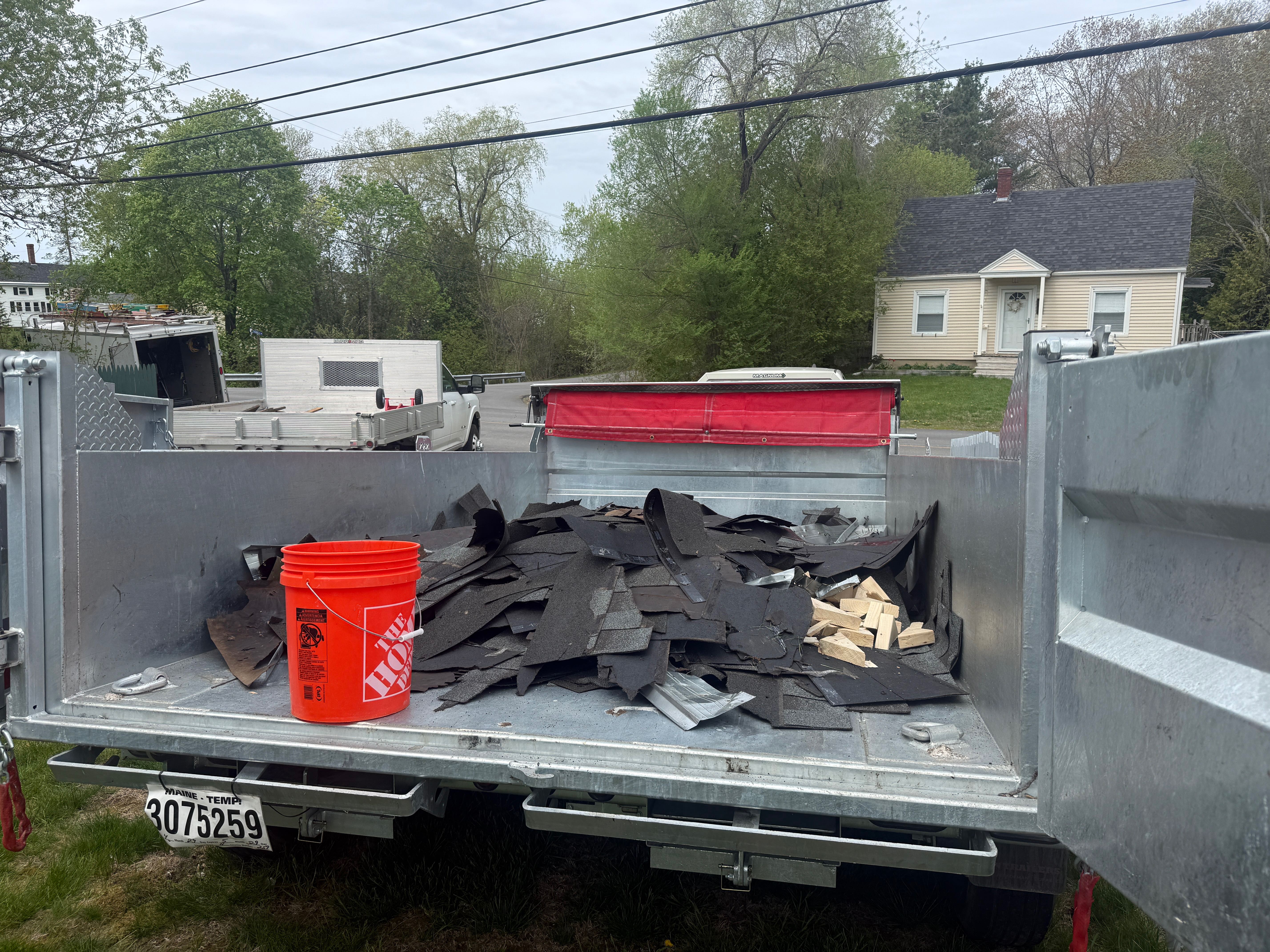Roofing debris loaded in dump trailer