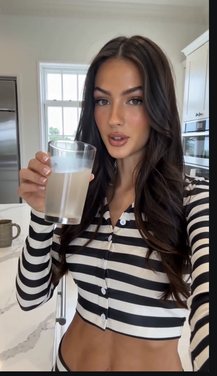 Woman drinking a glass of VIVRA