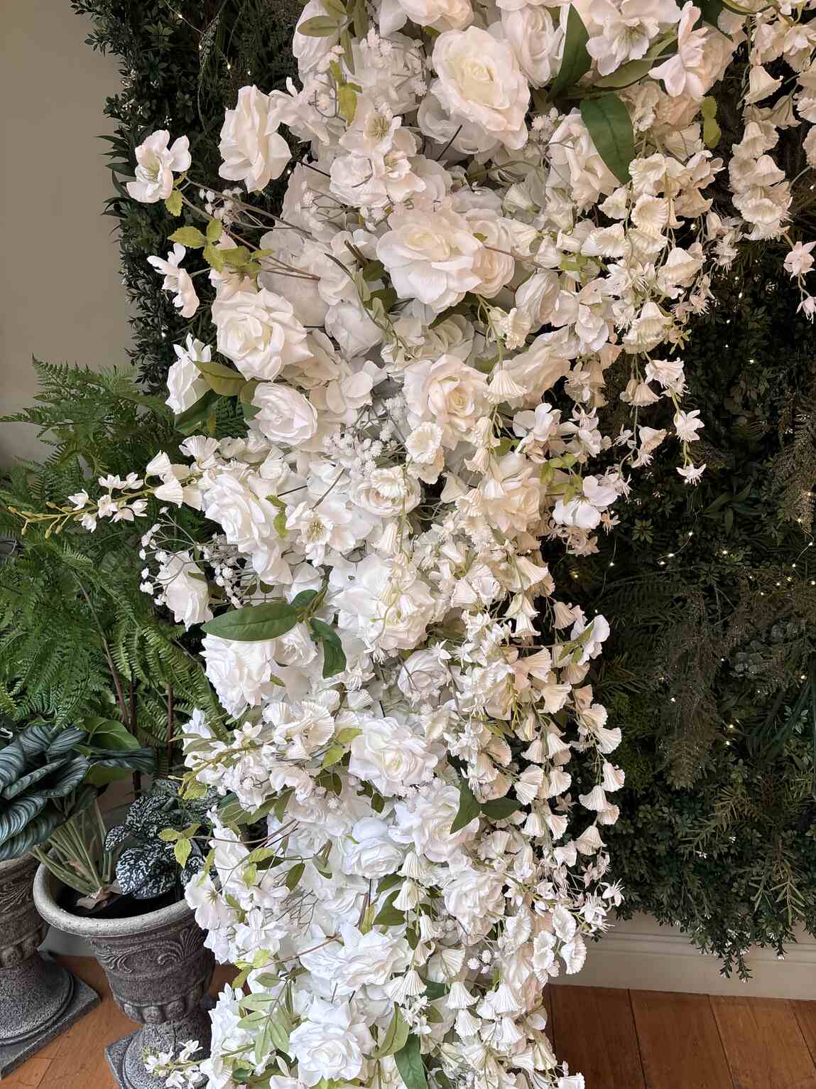 Detailed white wisteria and rose arrangement