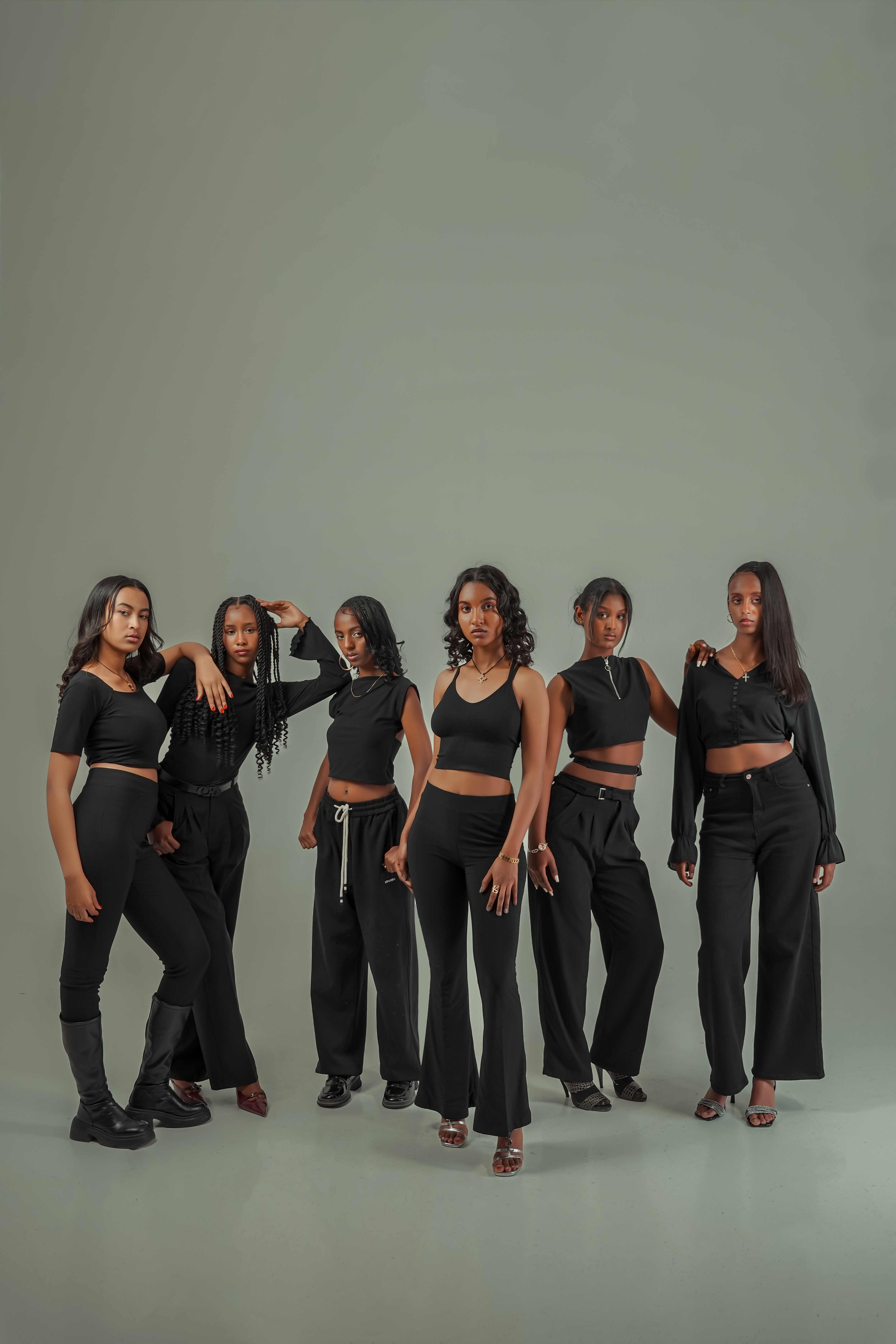 Six models in coordinated black outfits
