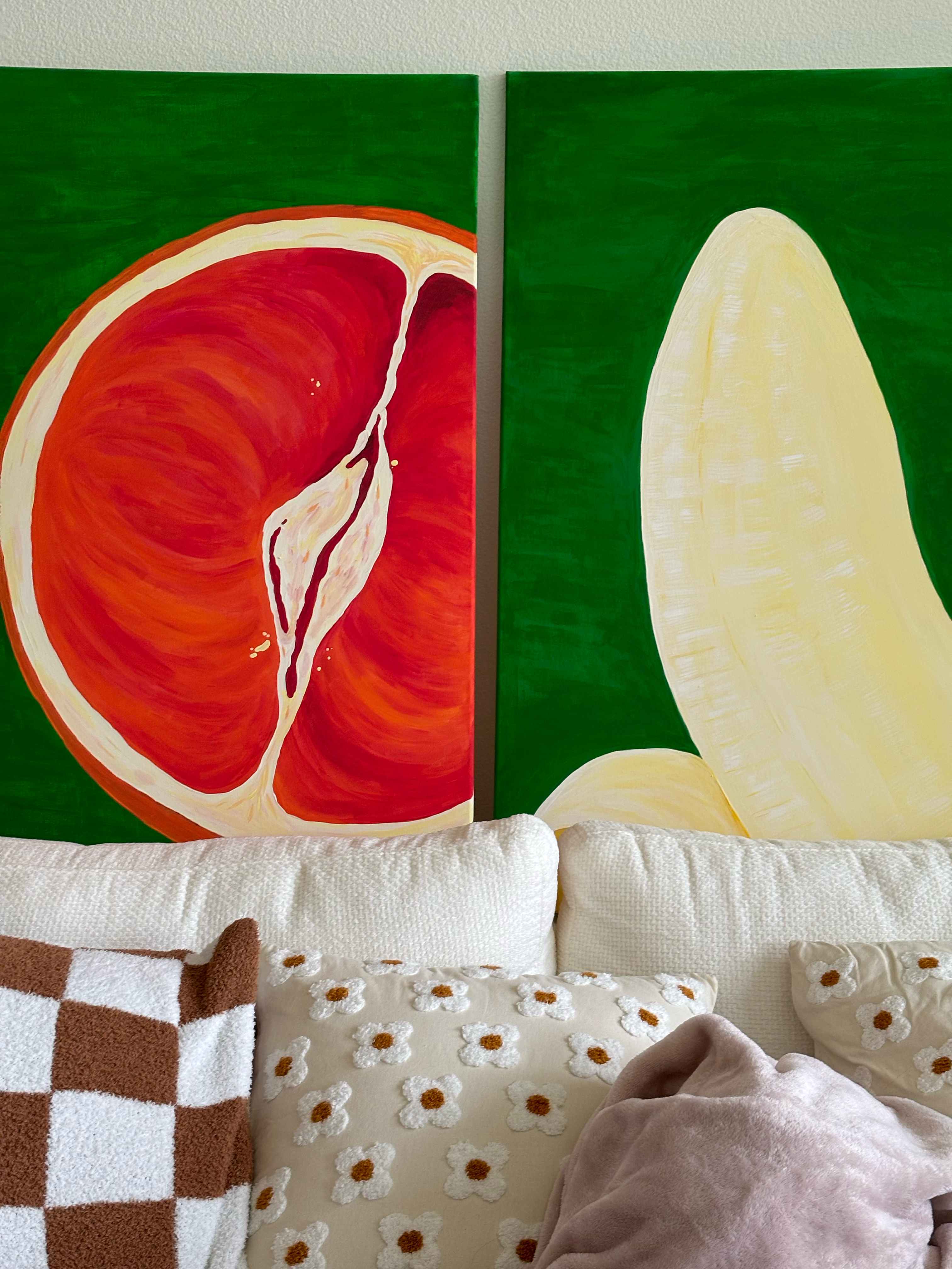 Grapefruit and banana paintings on green background