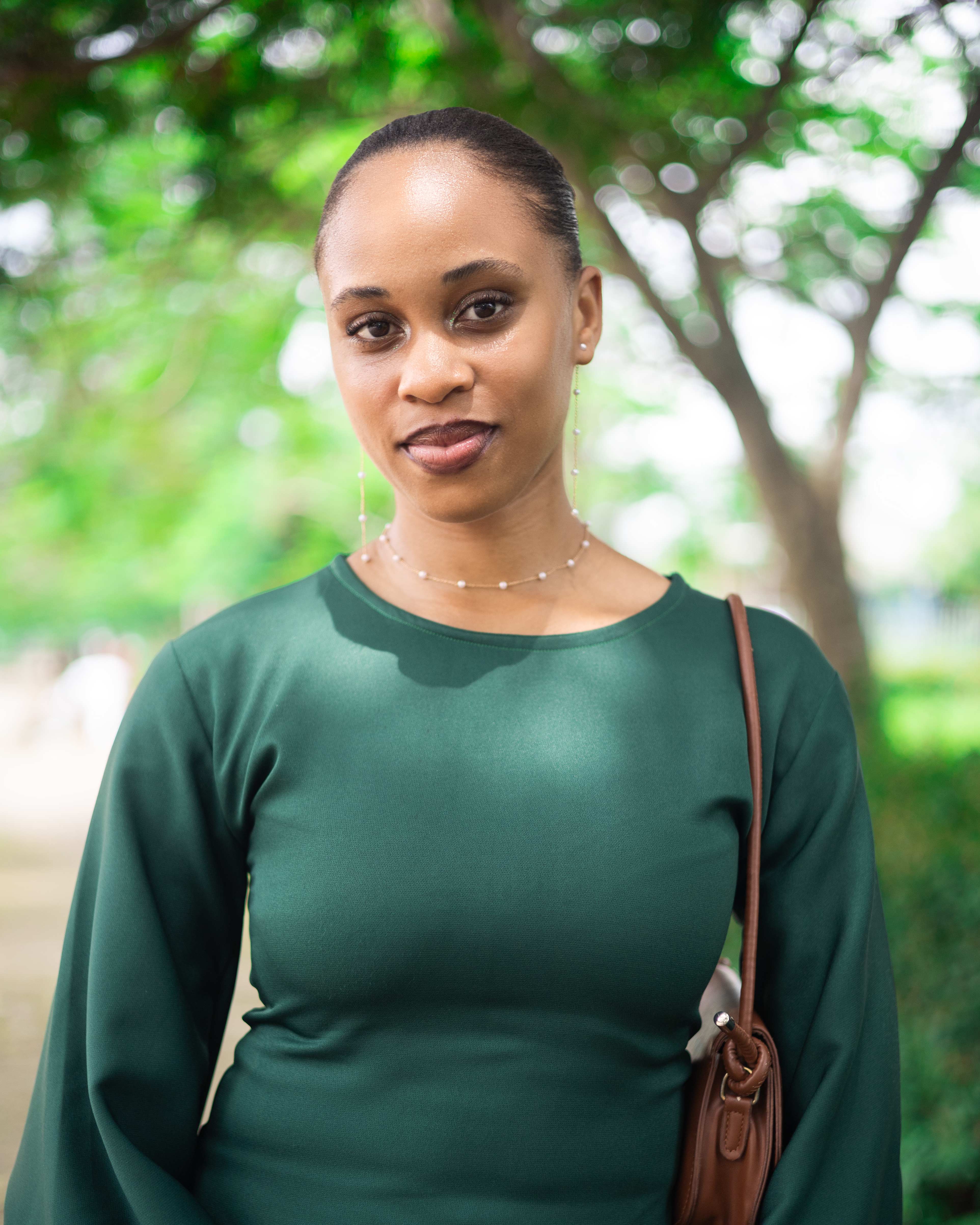 Close portrait of a graduate in a green outfit