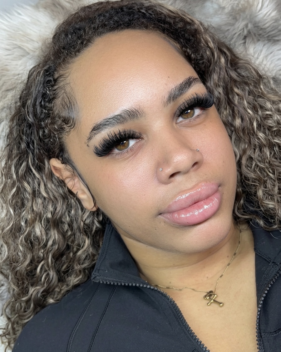 Client wearing a full lash extension set, photographed close up.