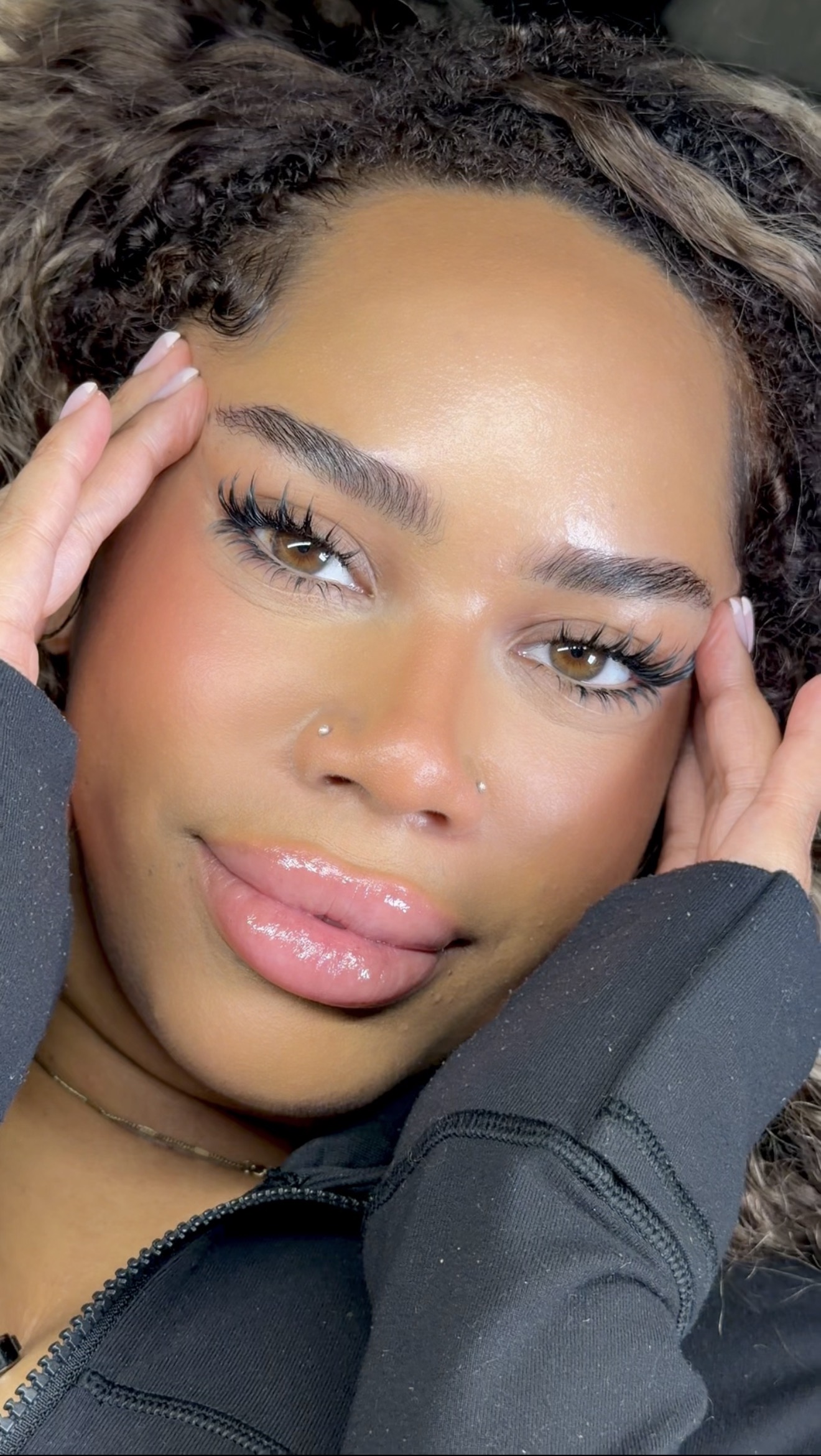 Client wearing a custom-designed lash set, photographed close up.