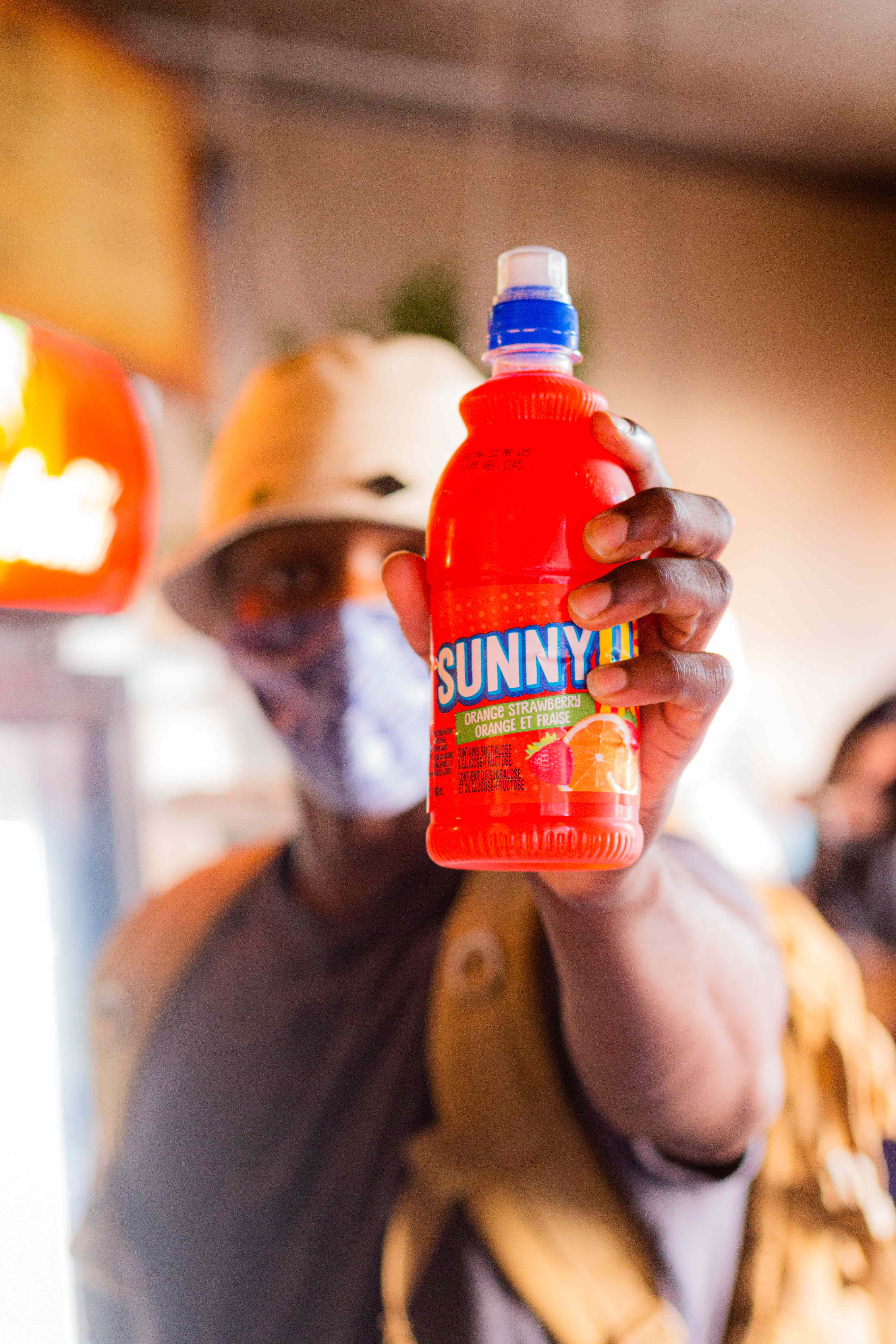 Person holding Sunny D bottle