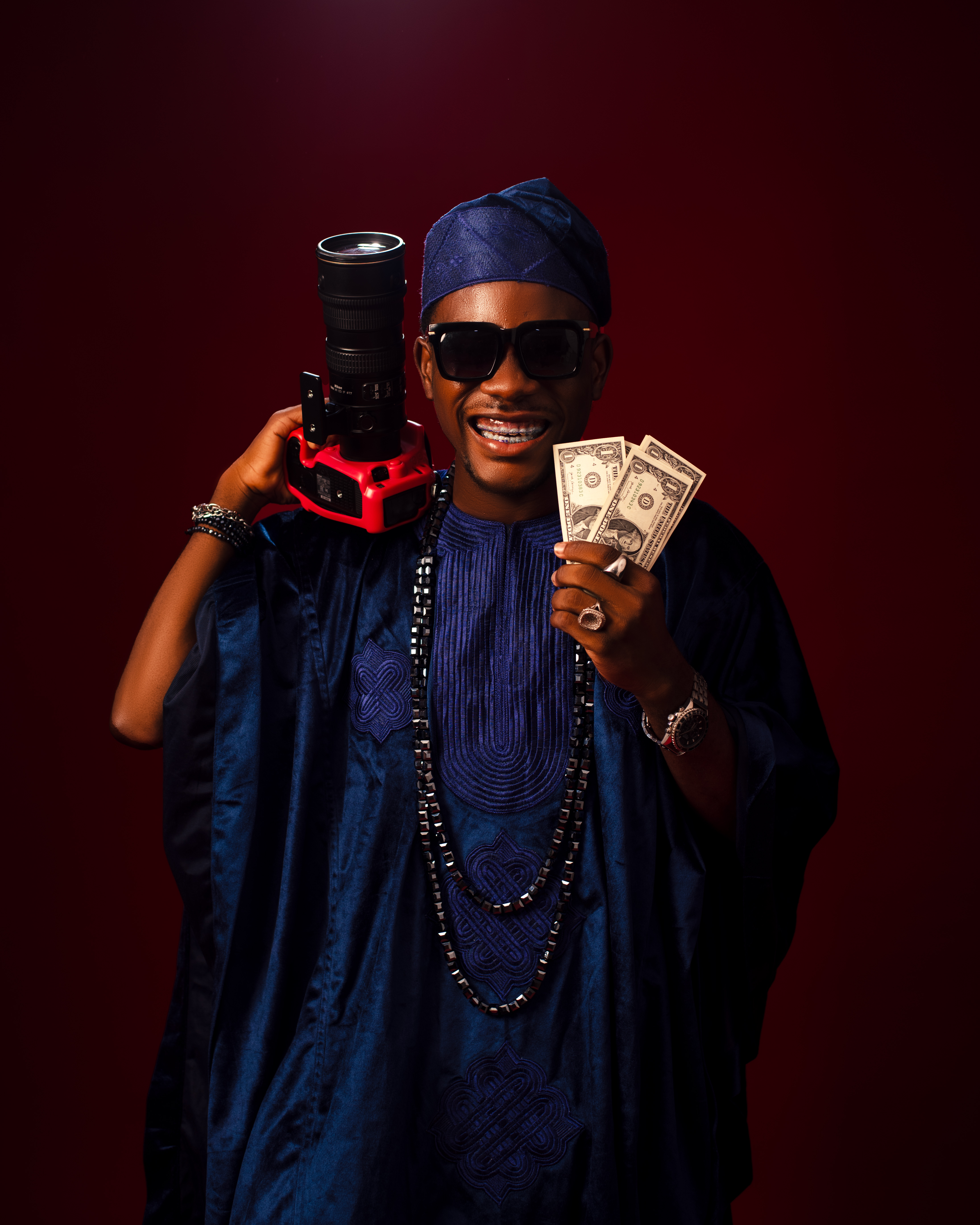 Ogbenini Studios photographer portrait with camera
