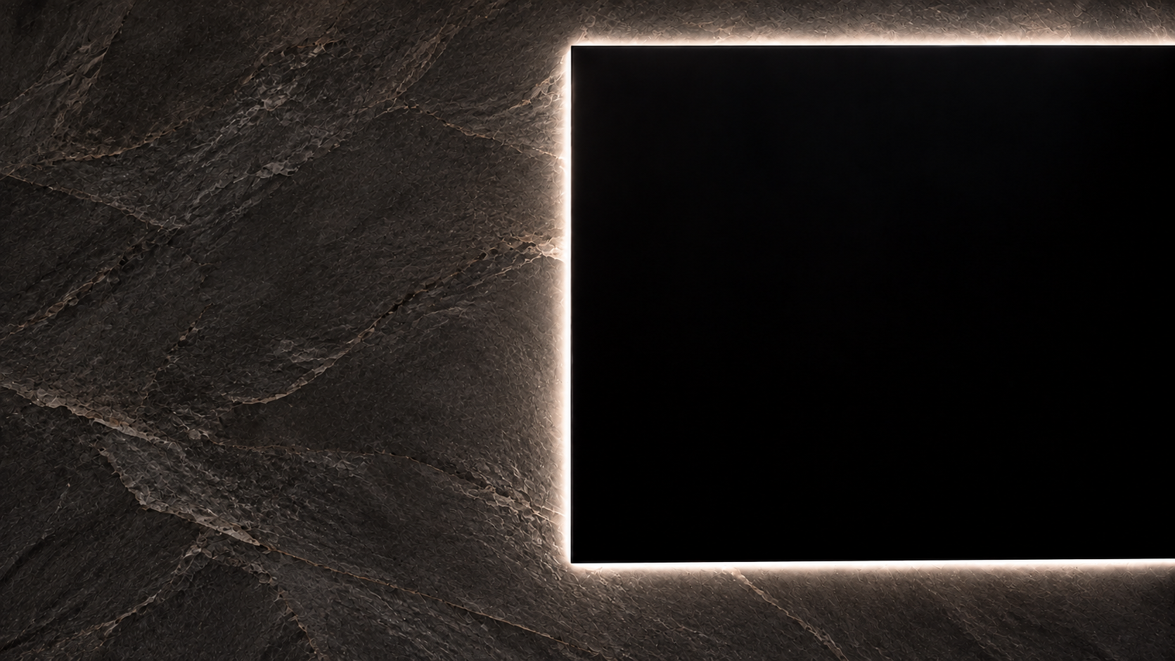 Illuminated black LED display on a dark textured slate wall
