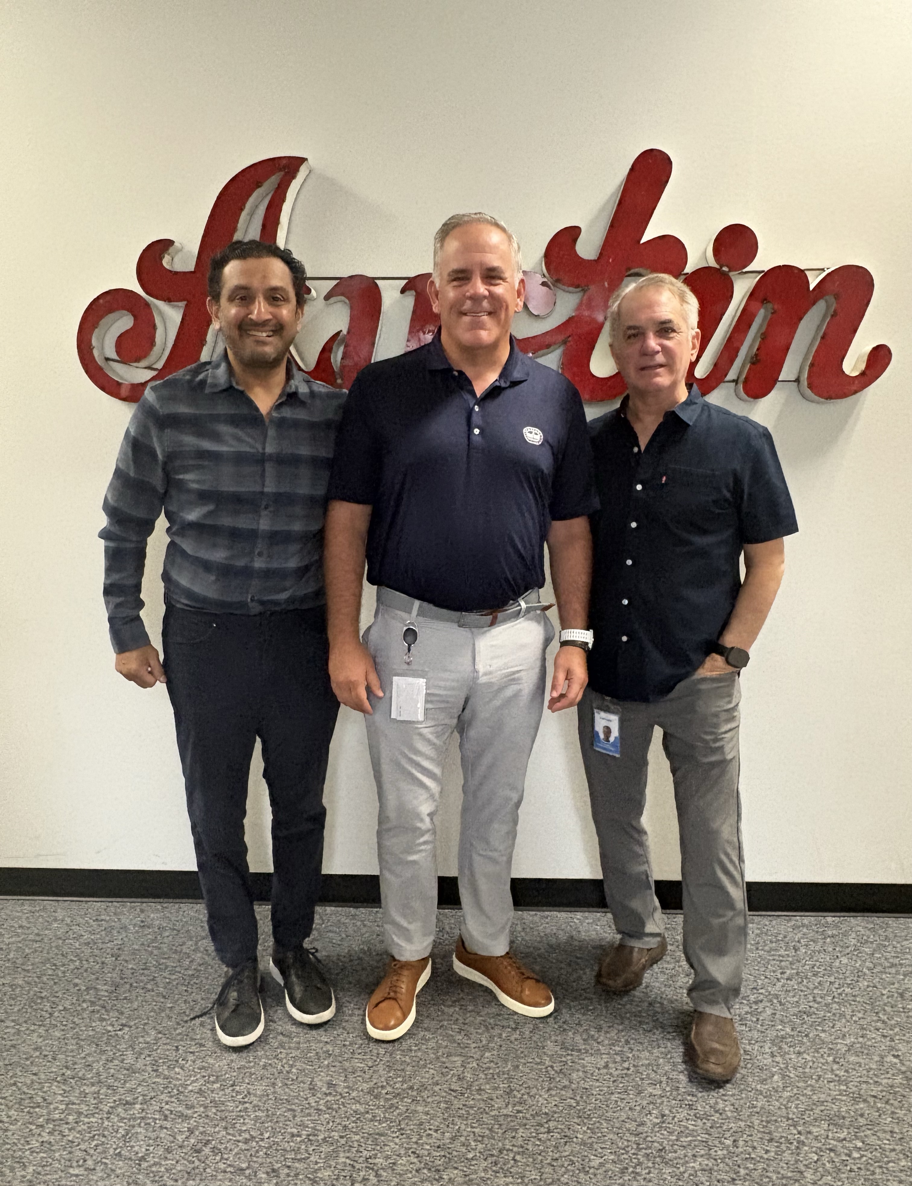 CTS Mobility team standing in front of the Austin sign