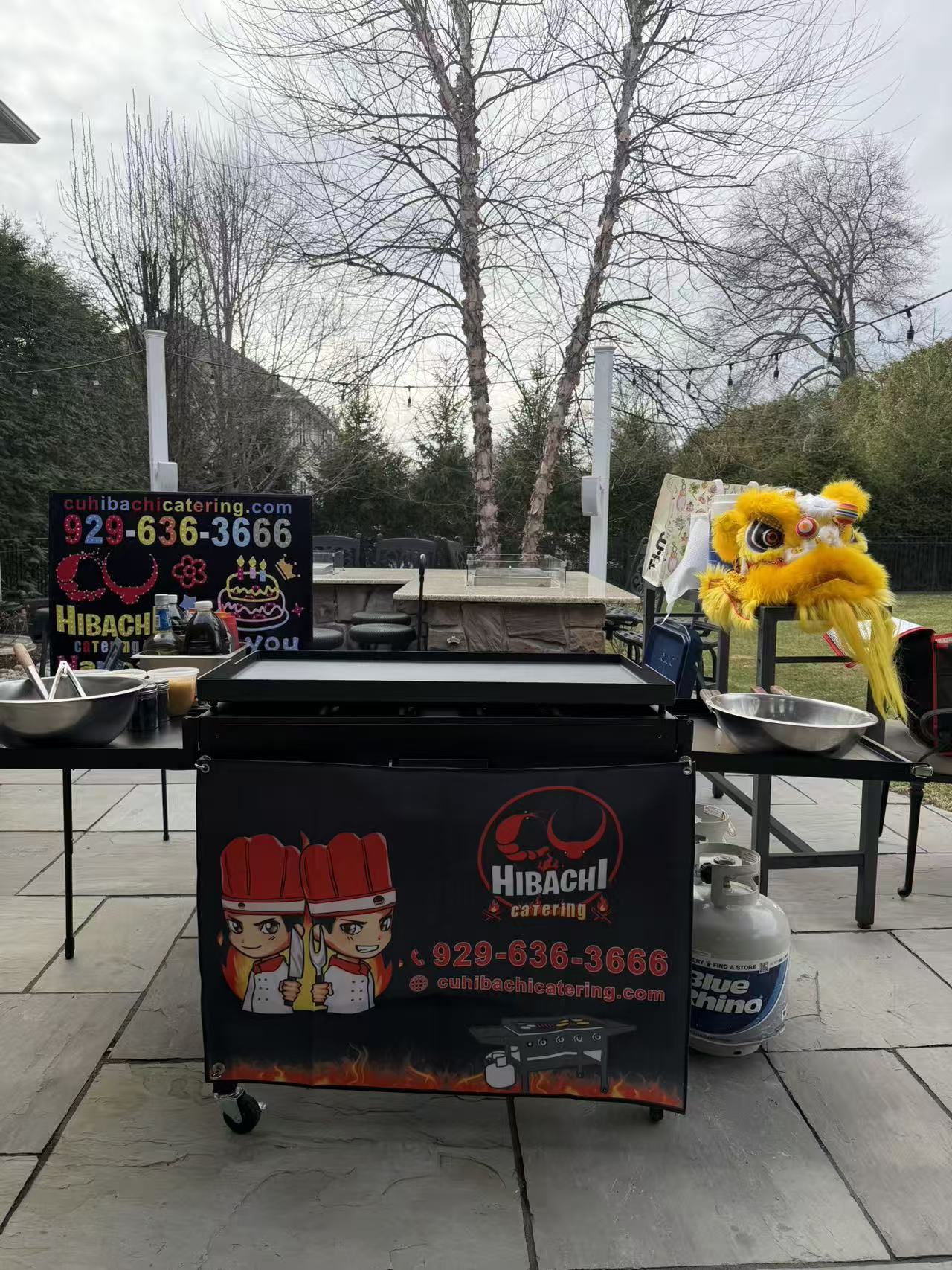 CU Hibachi Catering setup with branded grill cart and lion dance costume at outdoor event