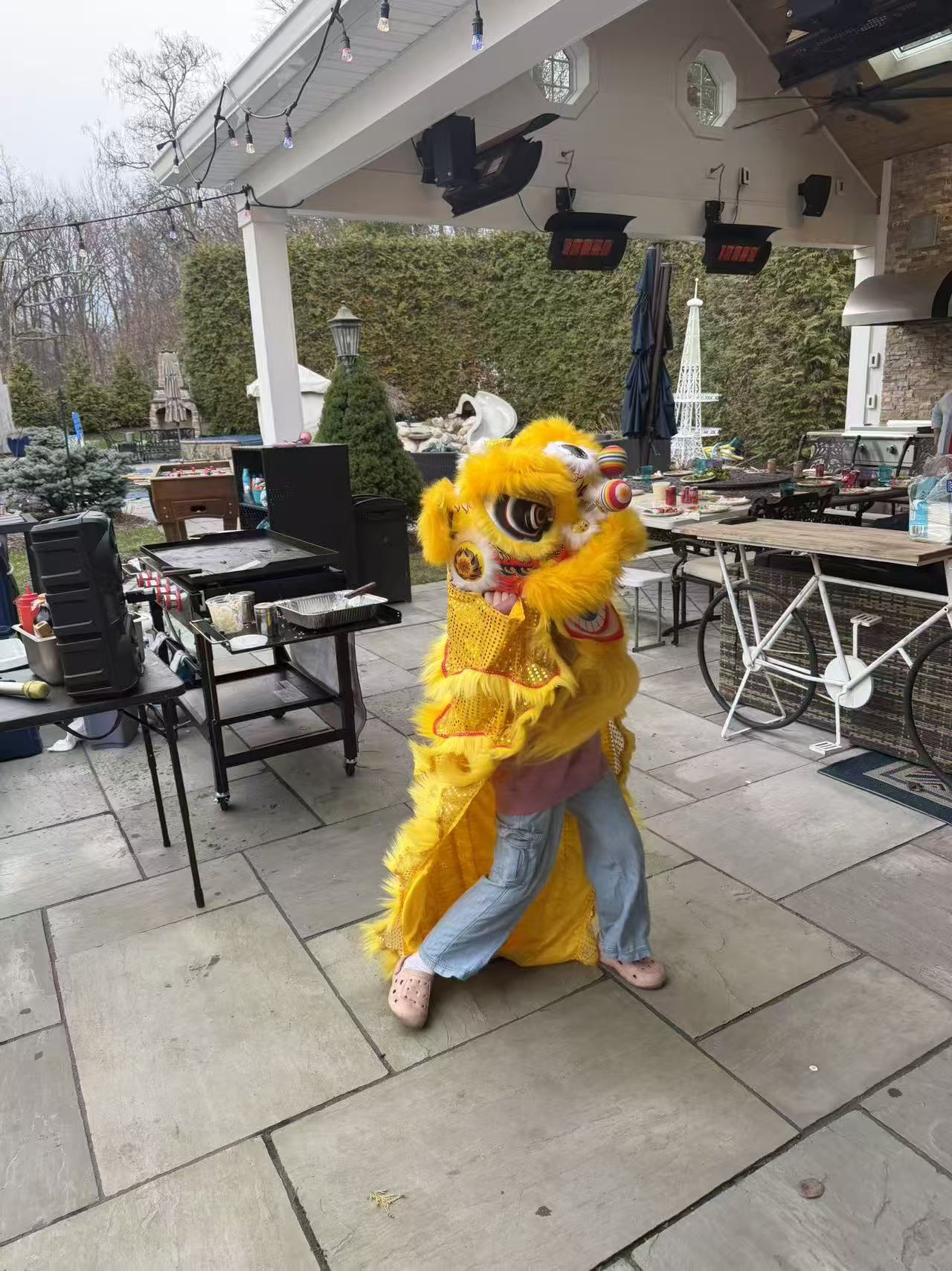 Yellow Chinese lion dance performance at hibachi catering event