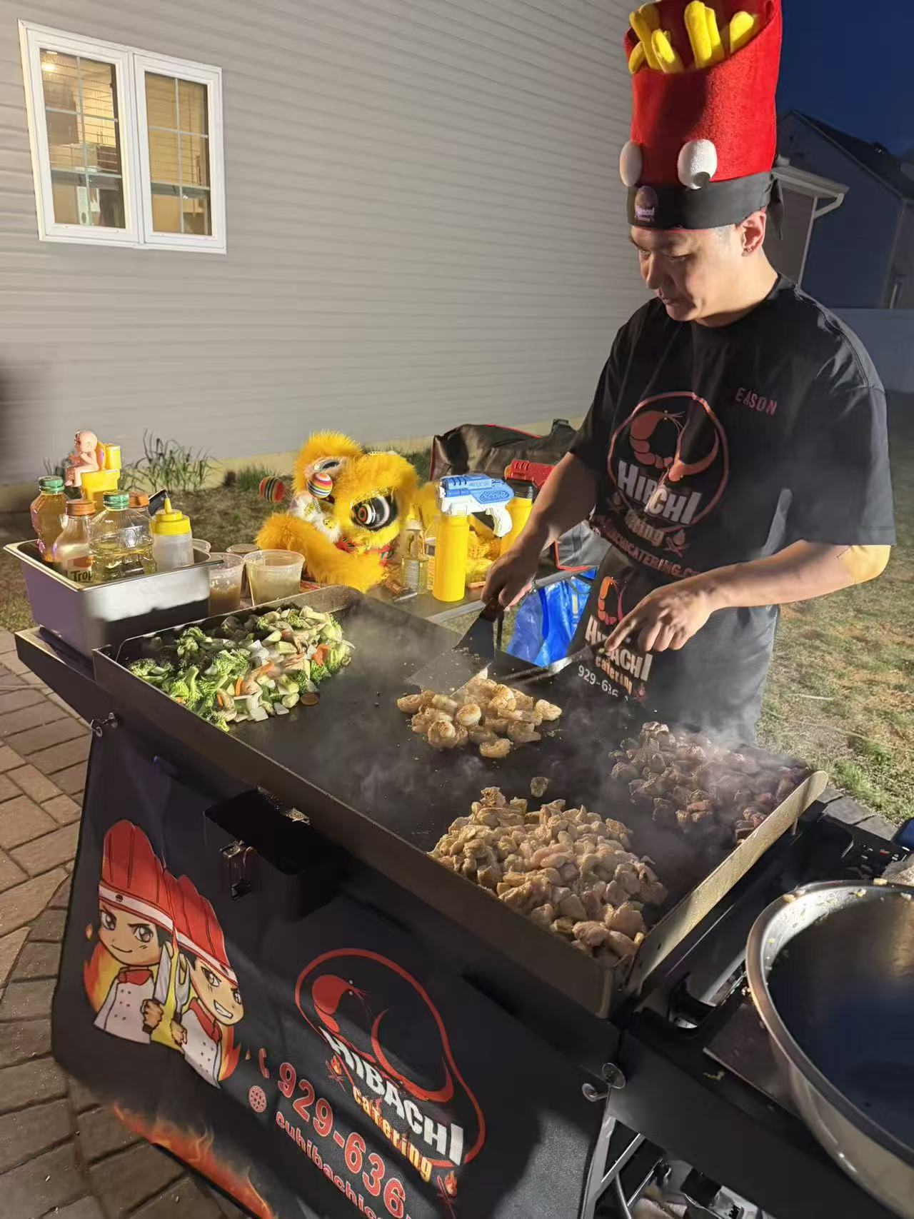 Chef cooking shrimp, chicken and vegetables on branded grill with lion dance costume
