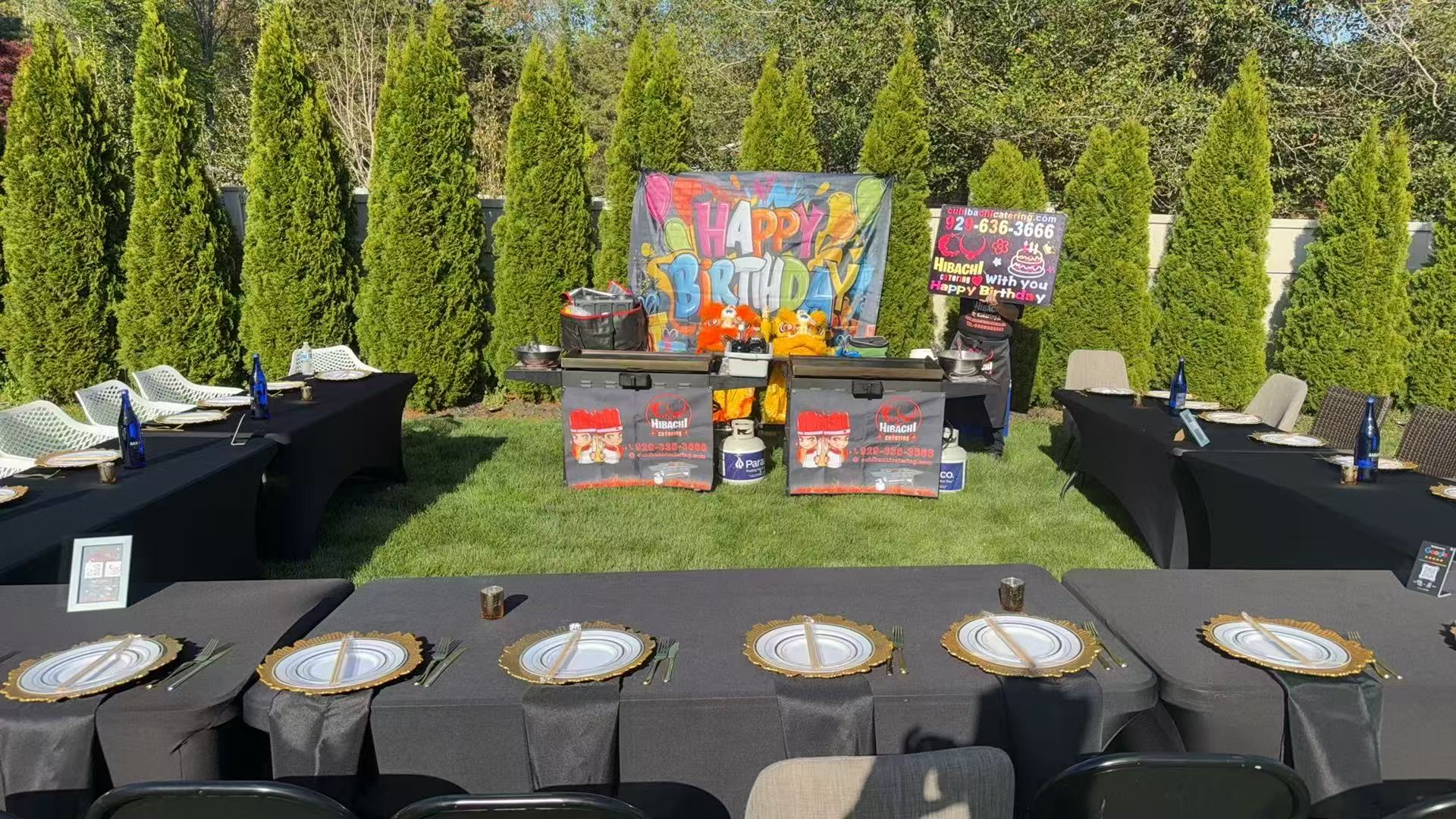 Elegant outdoor party setup with gold chargers and Happy Birthday graffiti banner