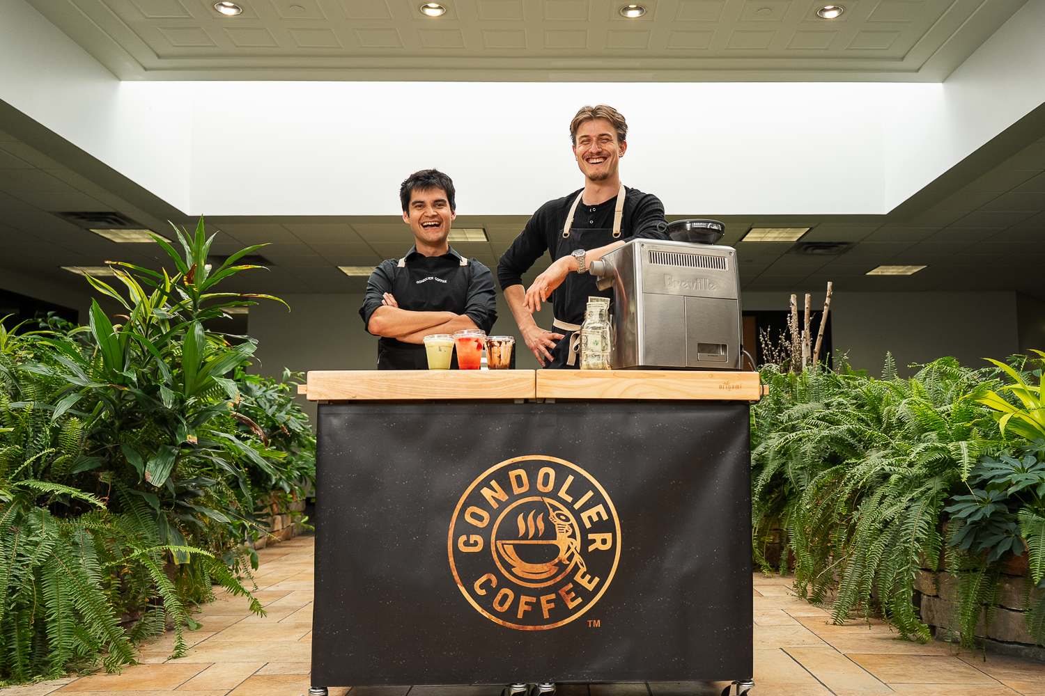 Smiling Gondolier Coffee baristas at mobile coffee cart ready to serve