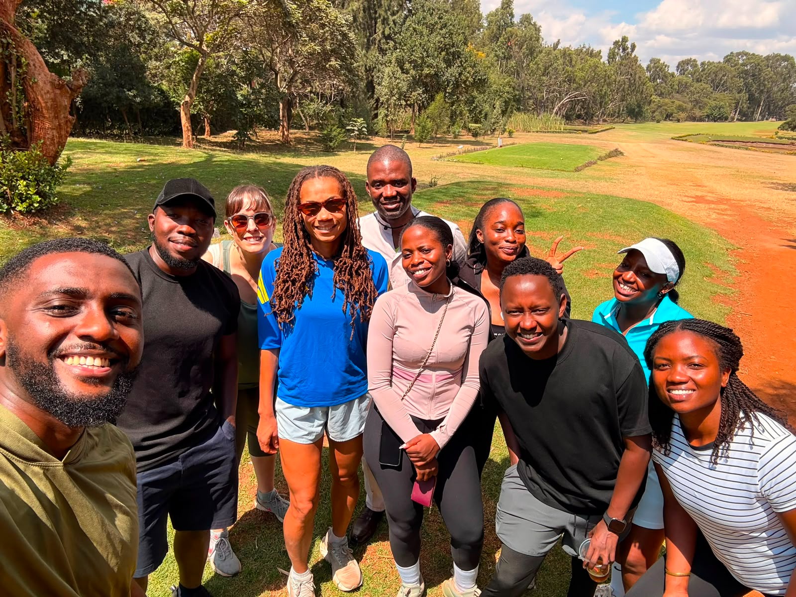 A diverse travel group enjoying a sunny day together outdoors
