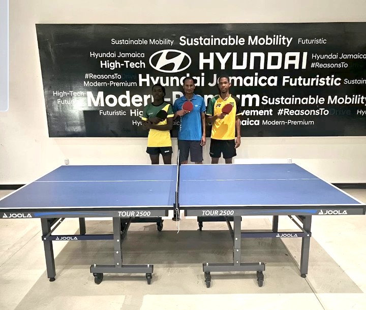 Three players at a JOOLA table in front of Hyundai Jamaica branding — JTTPA 2025 season