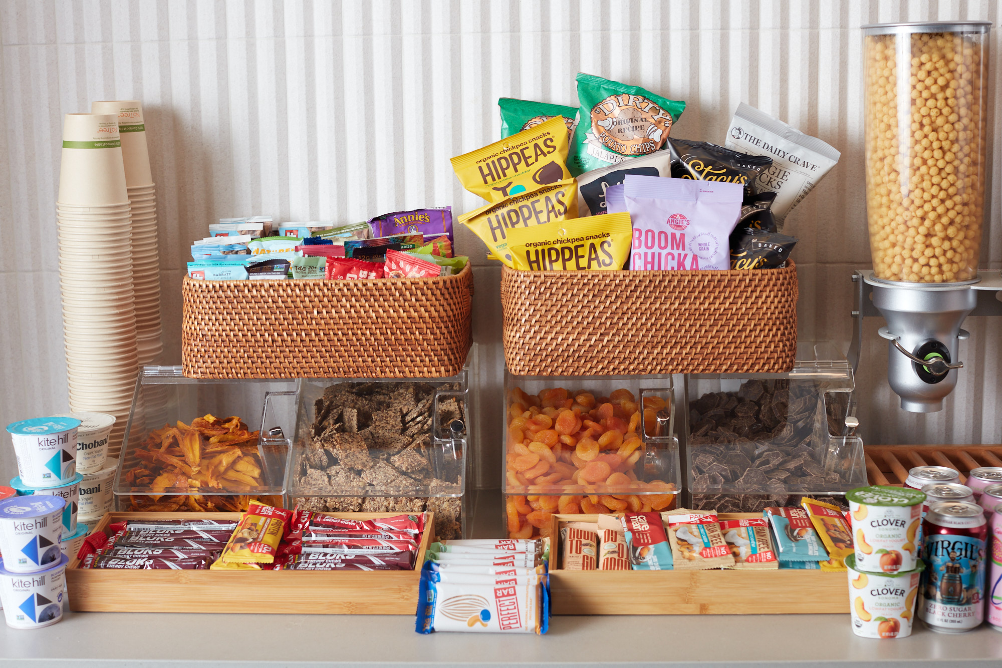 Grab-and-go snack station with chips, dried fruit, granola bars, and drinks