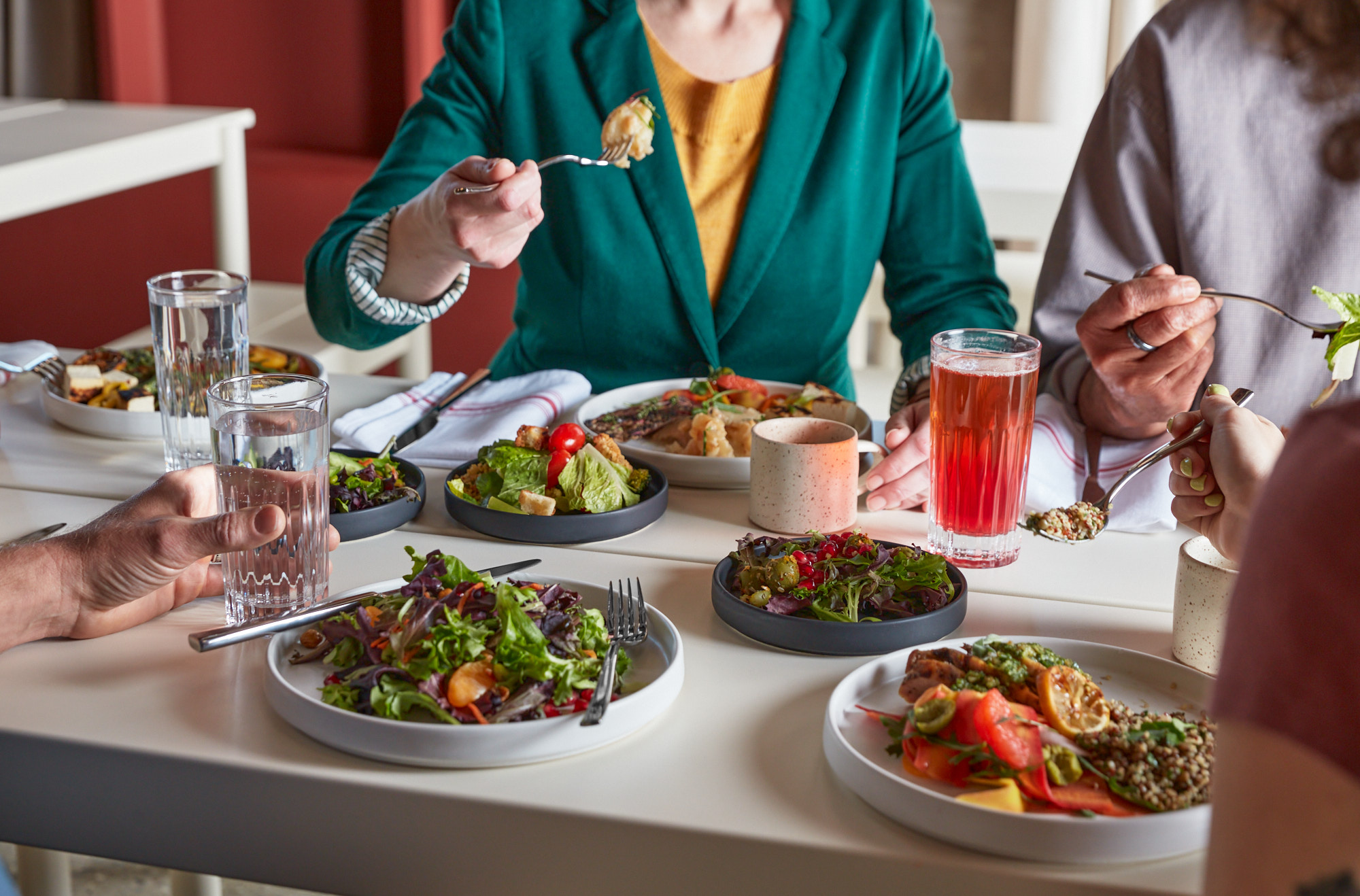 Team dining together over salads, grain bowls, and drinks