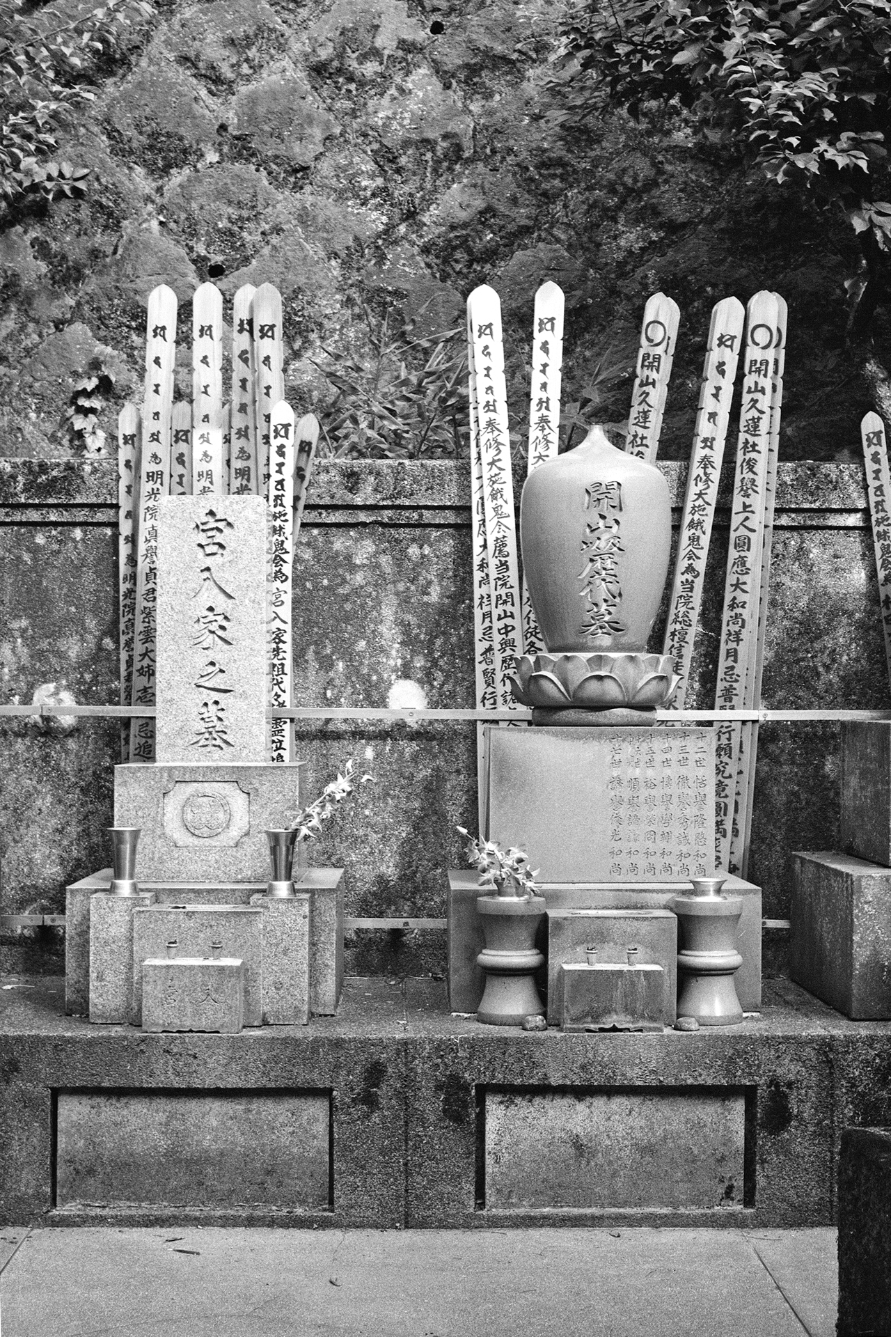Black and white traditional Japanese cemetery with memorial tablets sotoba and ceramic urns