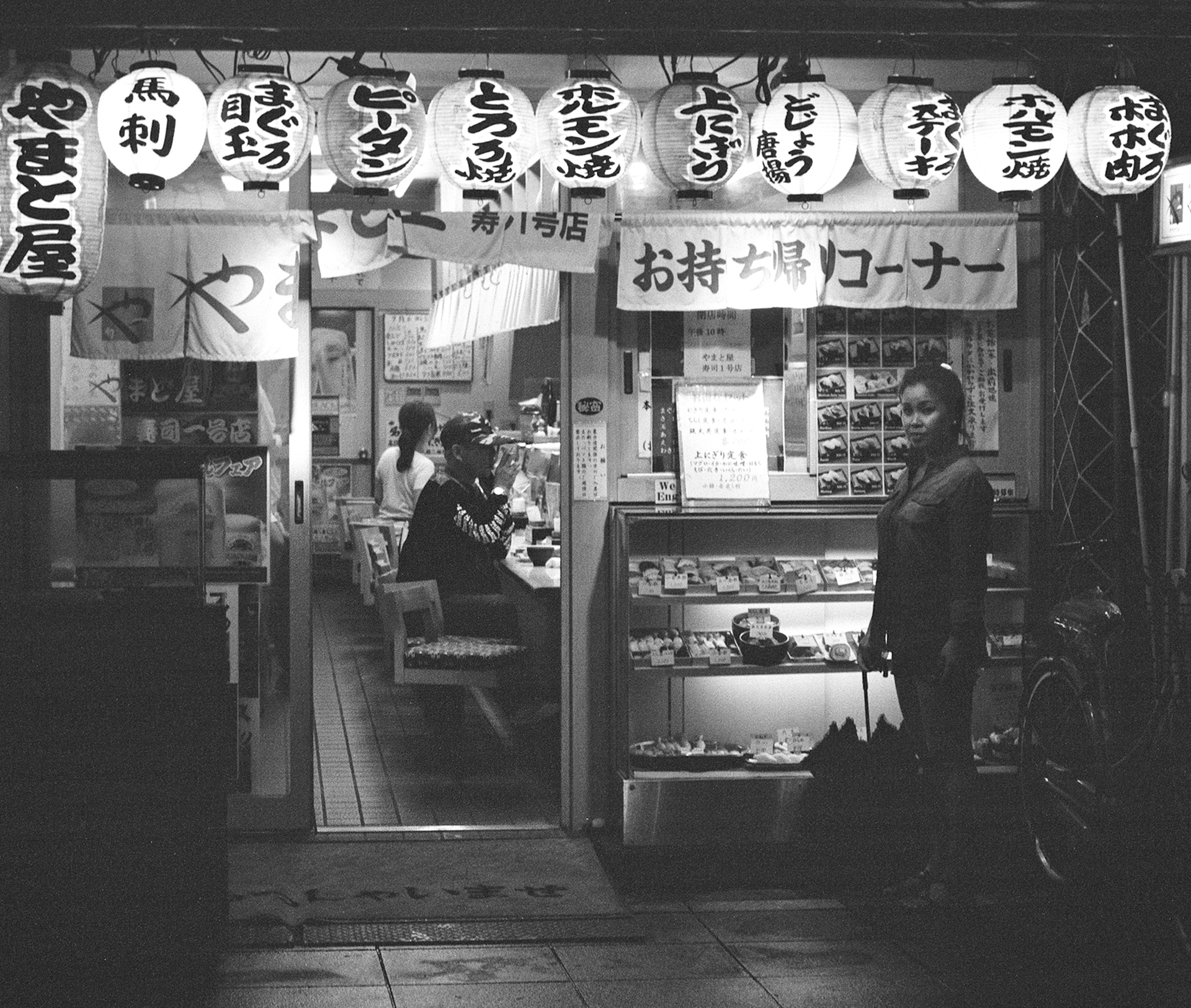 Black and white multi-story building with CHANGE signage mixed architecture scooter passing street scene