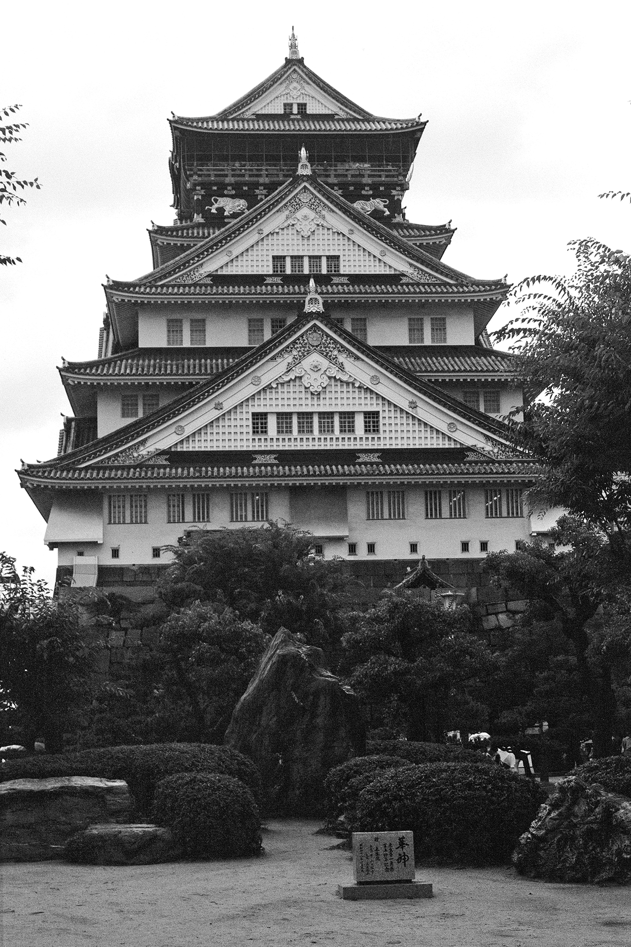 Black and white Hanbunko building with distinctive dormer windows Japanese signage intersection crosswalk
