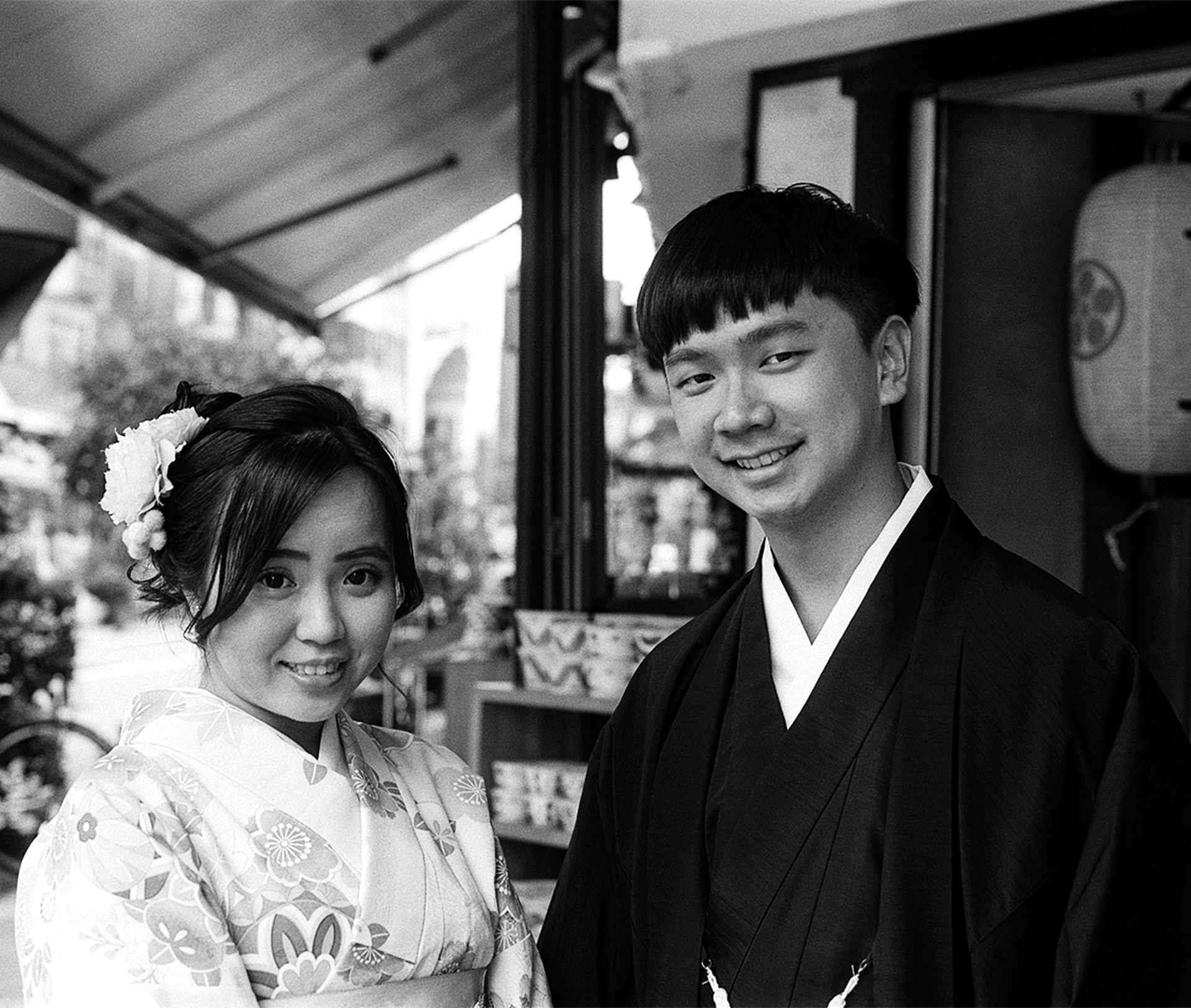 Black and white two women in kimono riding traditional rickshaw in Arashiyama bamboo forest