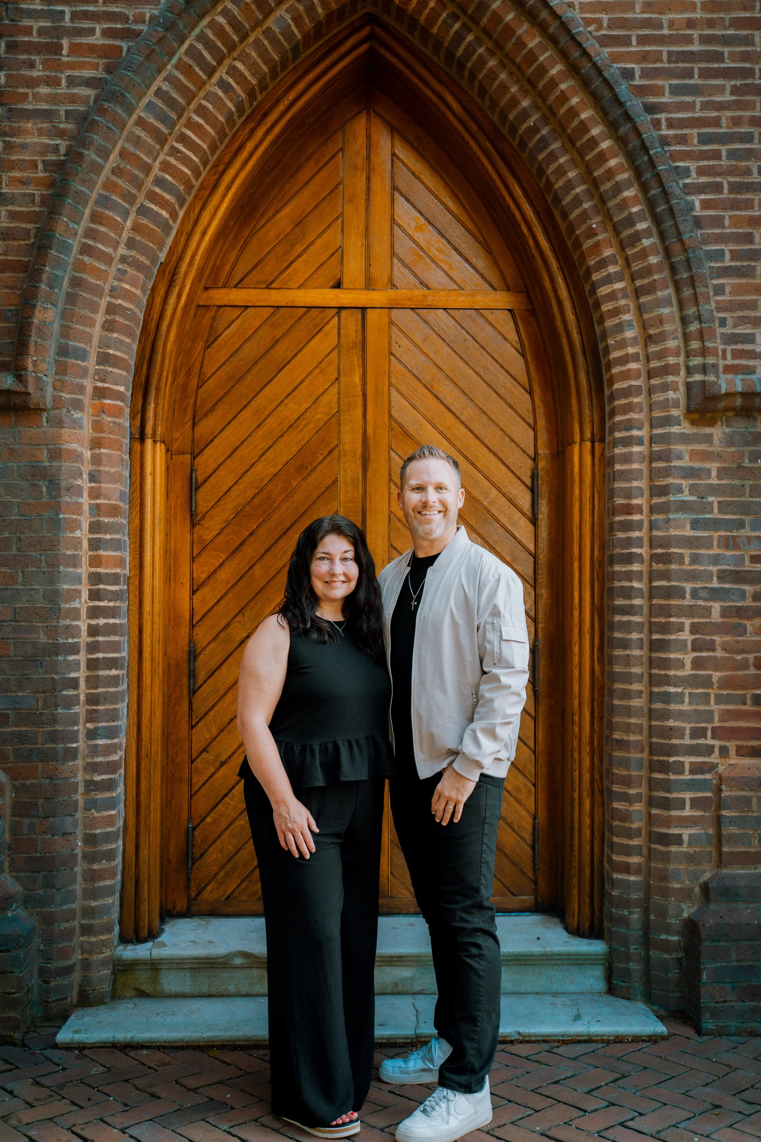 Jason and Jessica Parks standing in front of a church door